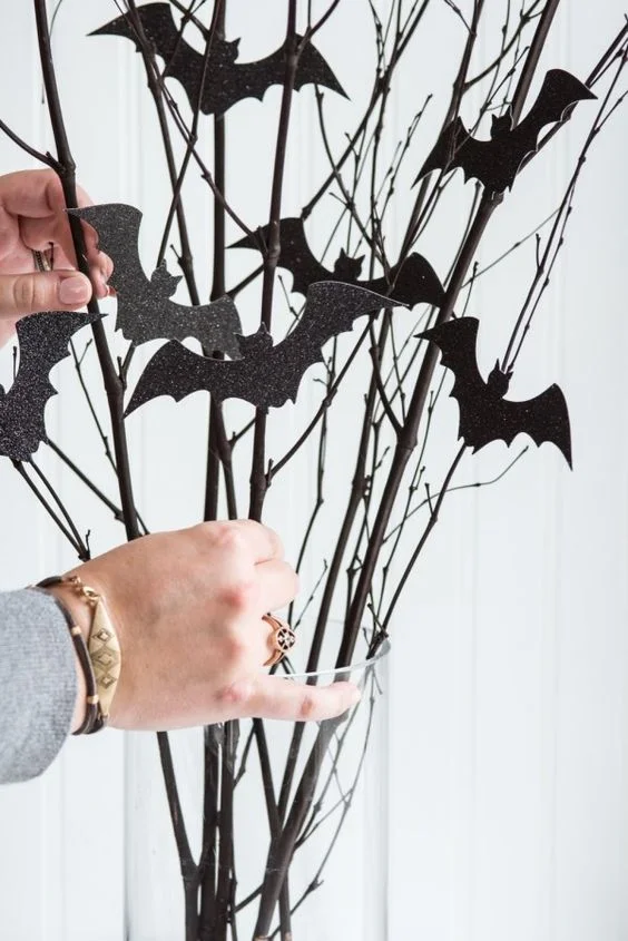 Affix bat silhouettes to a dried arrangement, or suspend them from the ceiling for extra dimension.