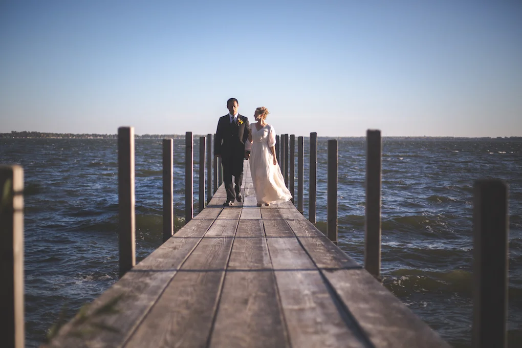 bride and groom on dock at spirit lake.jpeg
