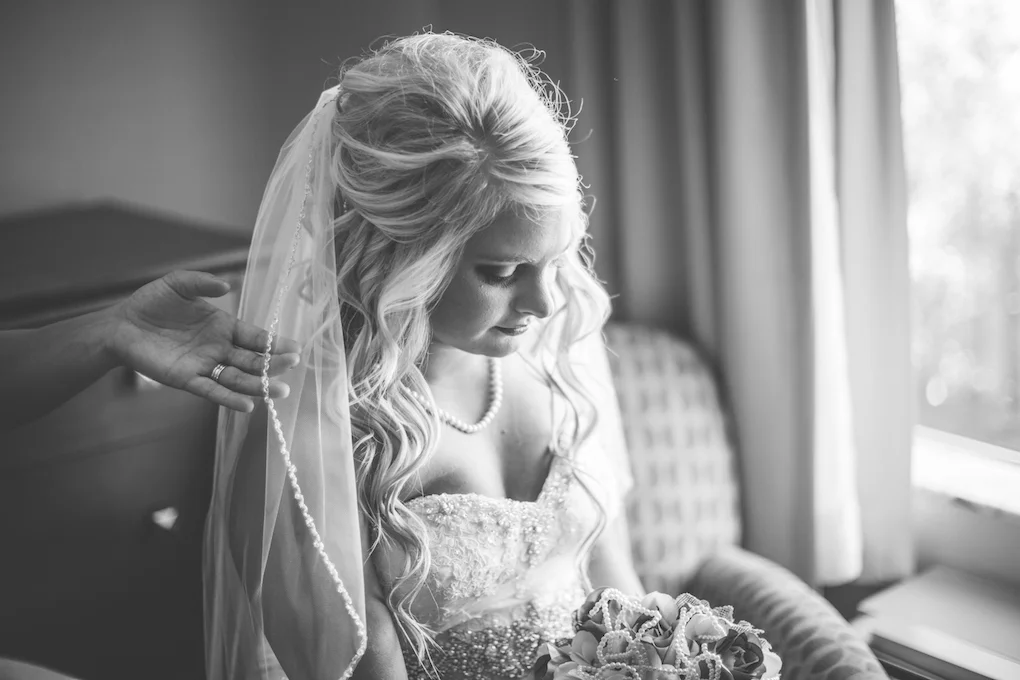 Bride with friends had adjusting vail.jpeg