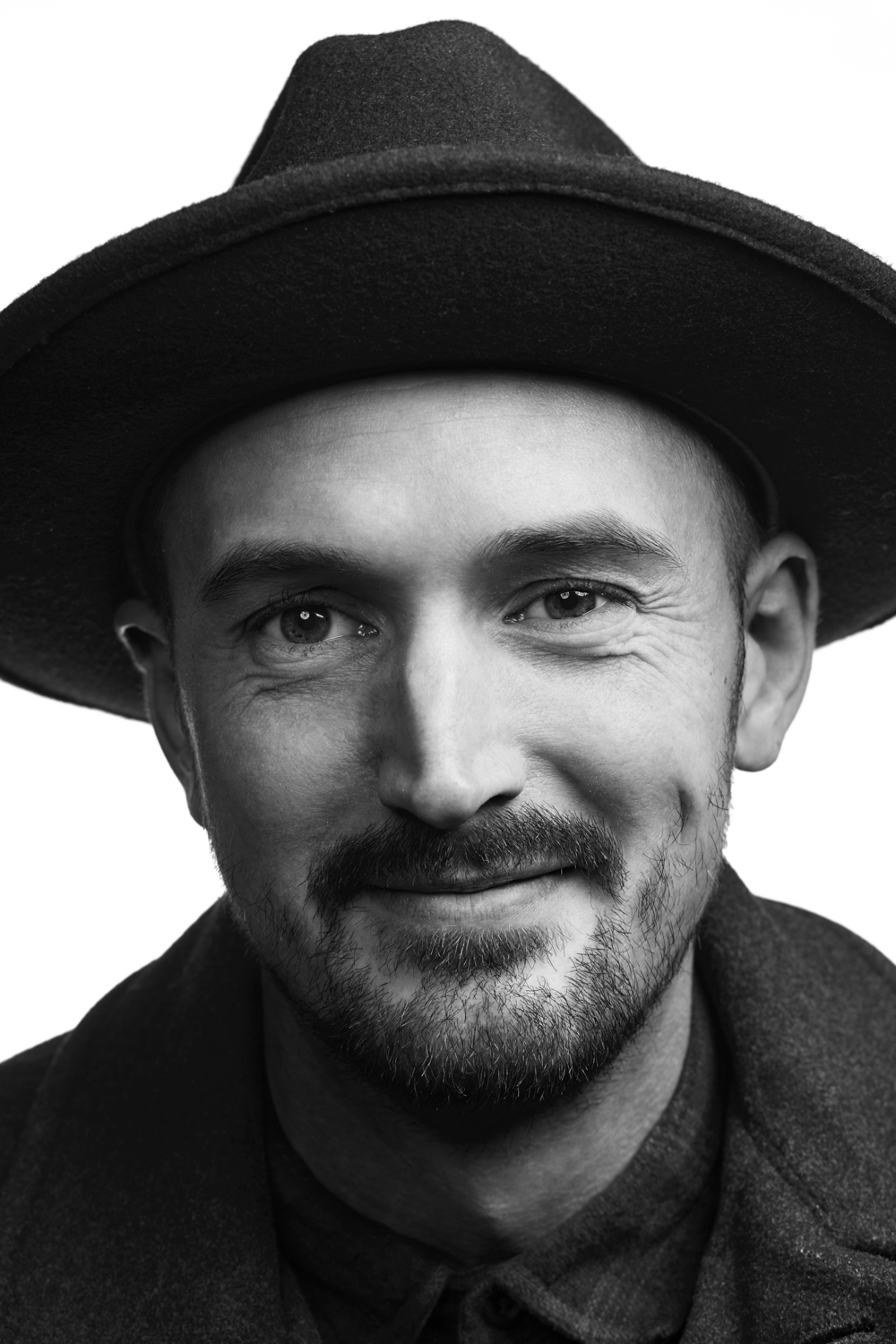 Man on white background, studio photography, black and white portraits, man in hat