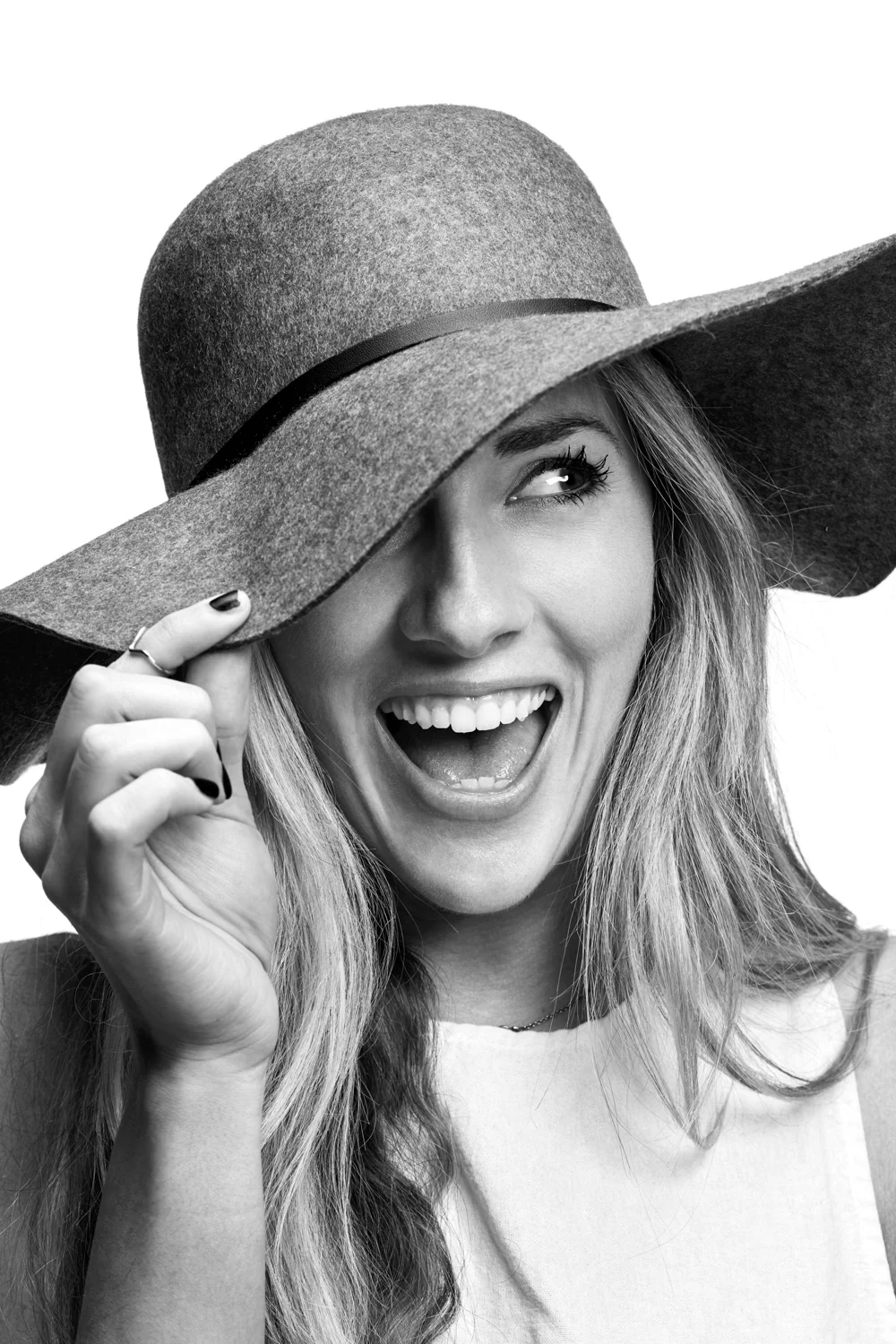 Woman on white background, studio photography, black and white portraits, girl laughing, girl wearing hat