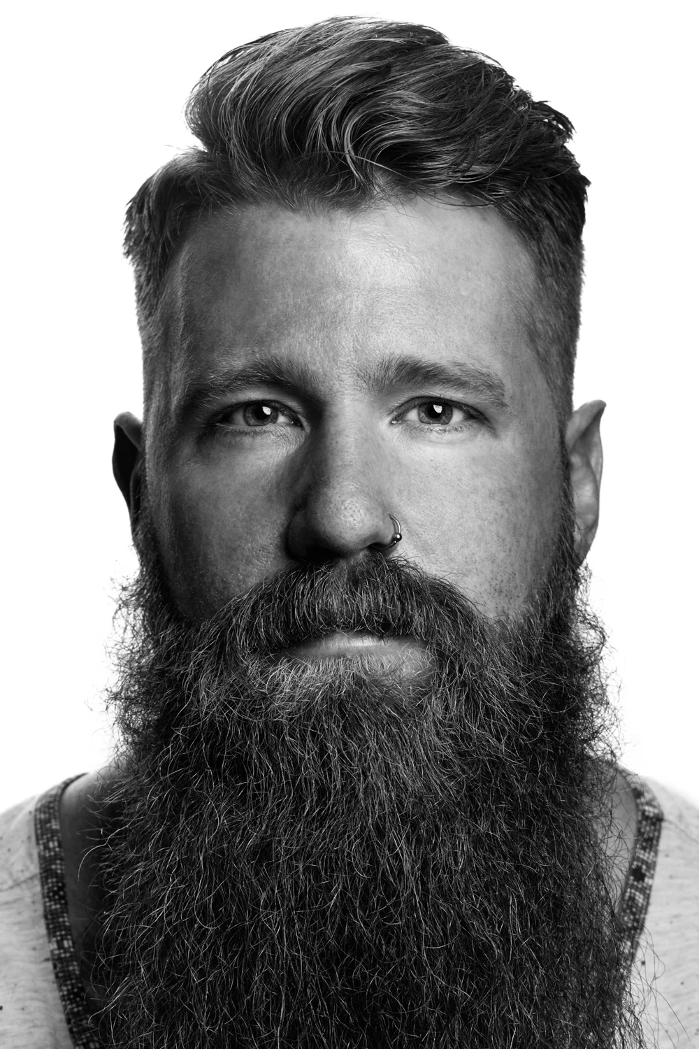Man on white background, studio photography, black and white portraits, hipster with beard, hipster with tattoos