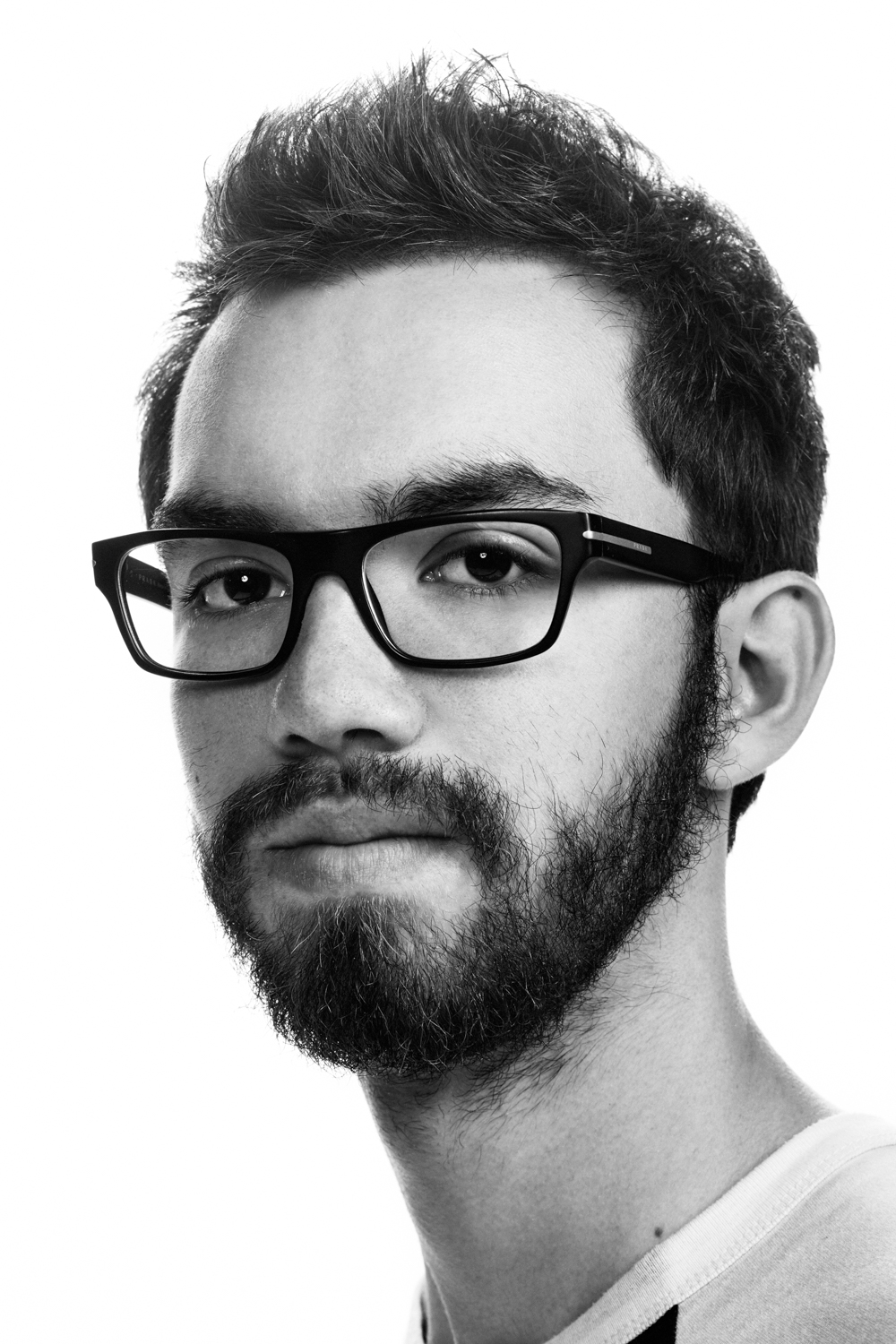 Man on white background, studio photography, black and white portraits, hipster with glasess