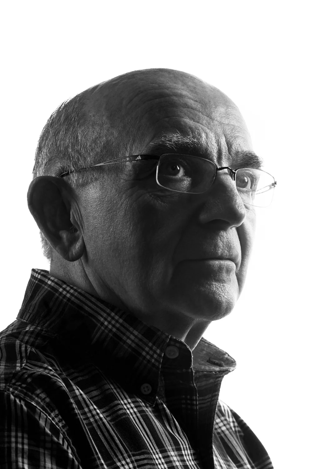 Man on white background, studio photography, black and white portraits, older man with glasses