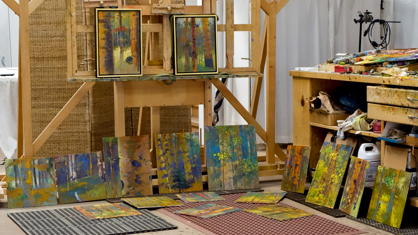 paintings in various states of the process at the studio