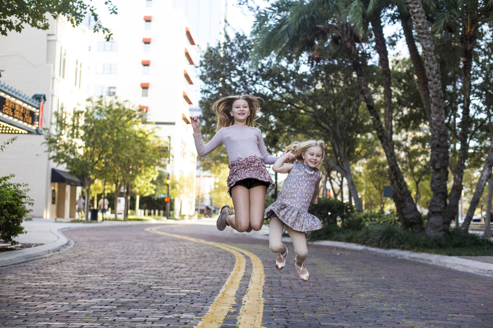 Girls jumping in downtown Tampa Street