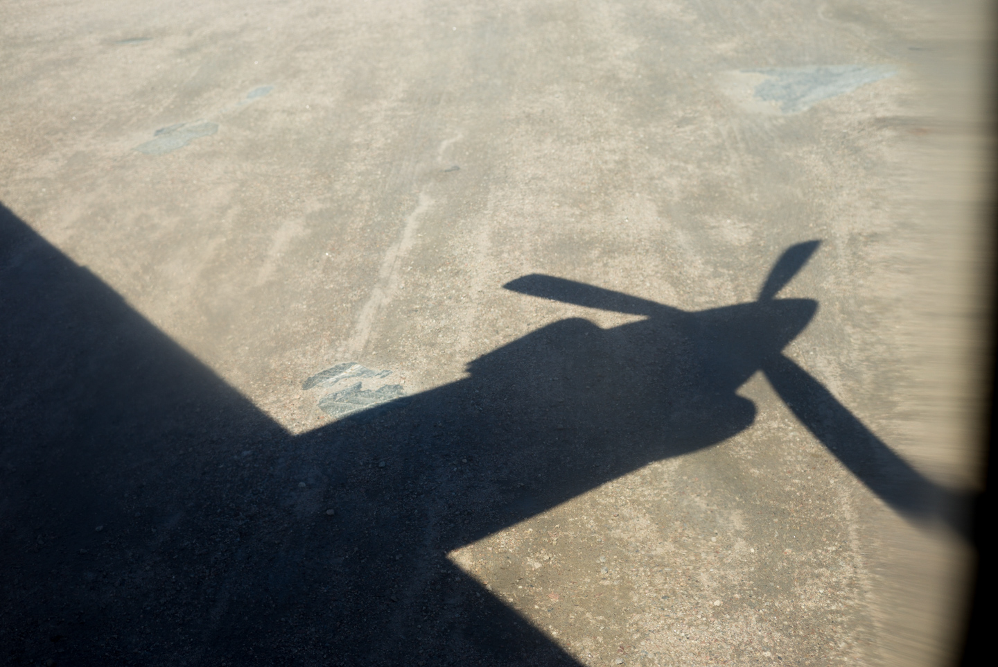 Shadow of the Innu Mikun plane on the gravel runway at William’s Harbour, Labrador 2016