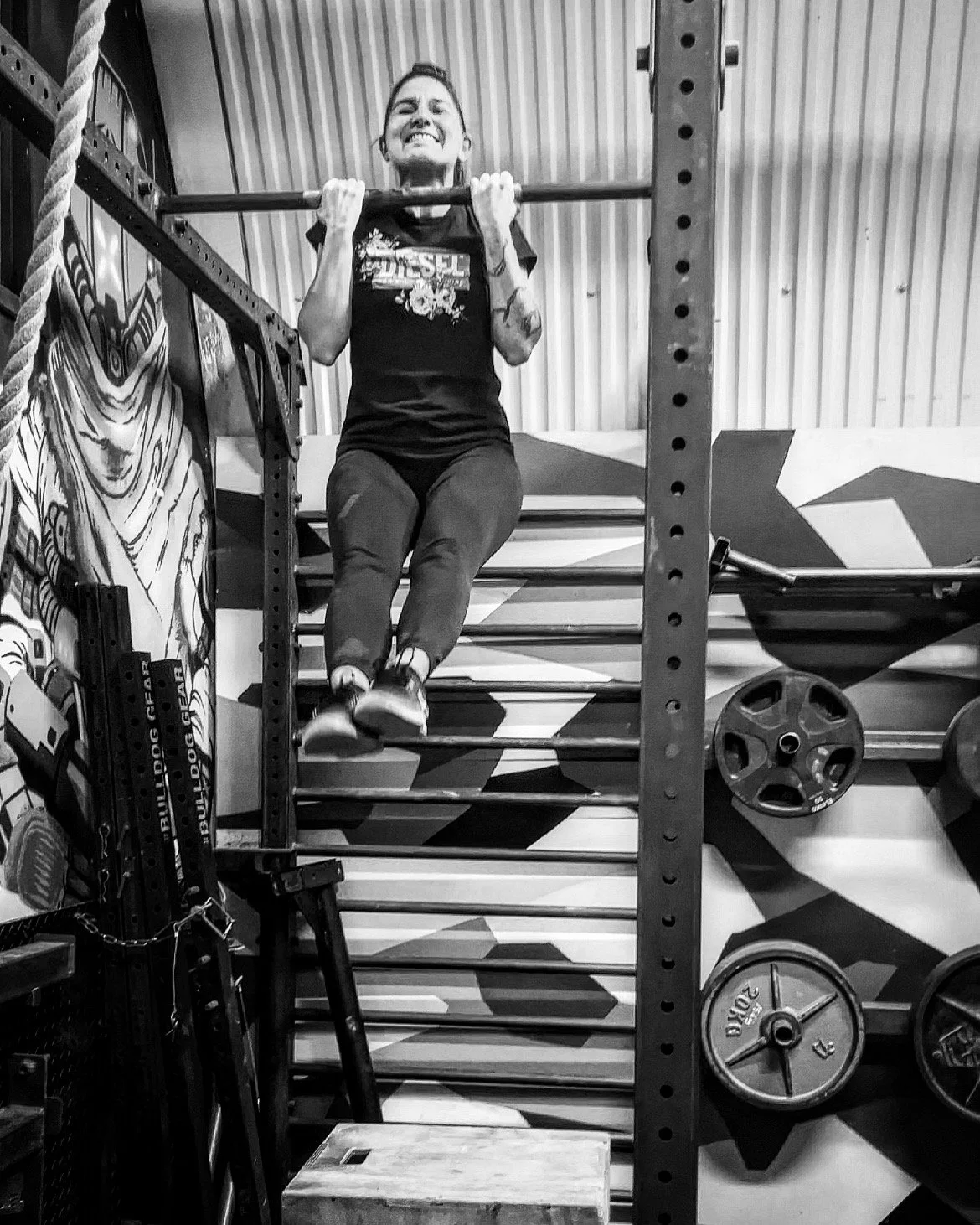 Claudia completing her first chin-up after strength training with BearWolf Training