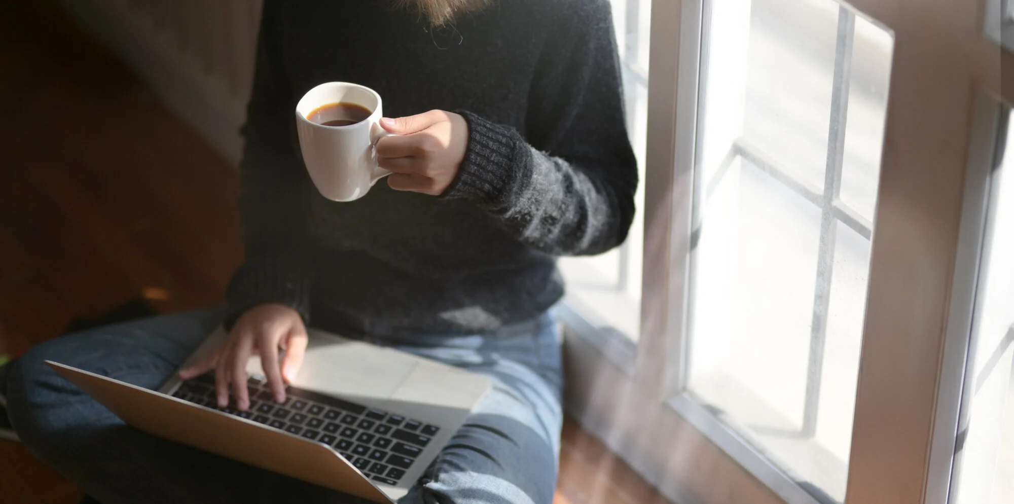 woman-using-laptop-while-holding-a-cup-of-coffee-3759083.jpg