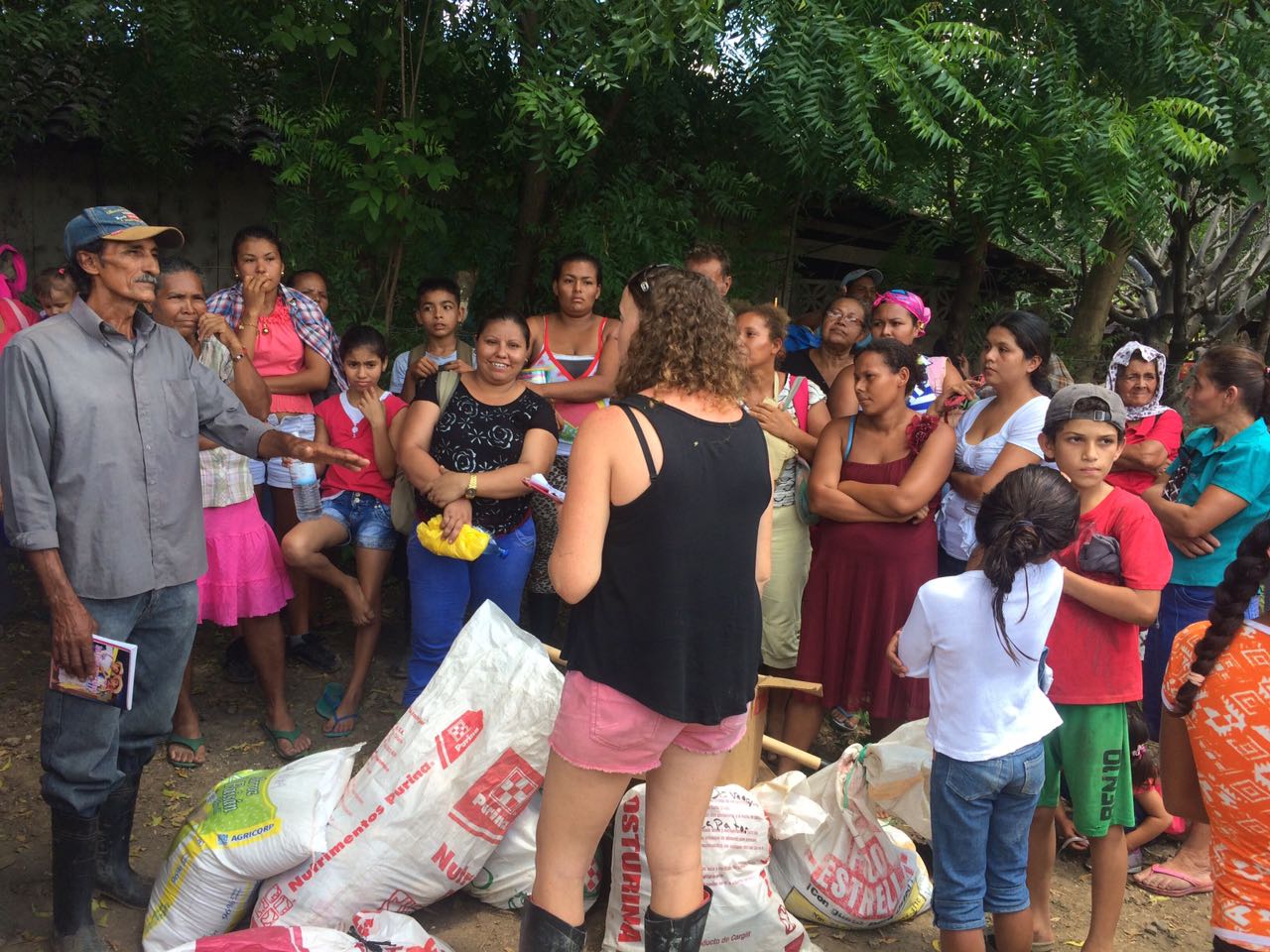 FIMRC Field Operations Manager, Jessica Southern meets with the community of La Uva. They are receiving supplies after walking down the hills for 2 hours.