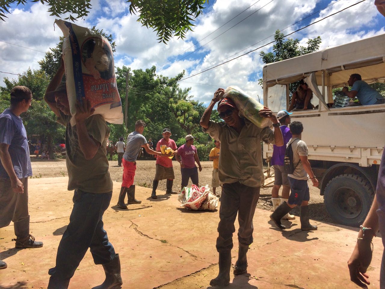 Unloading sacs of food for distribution in Barrio Nuevo.