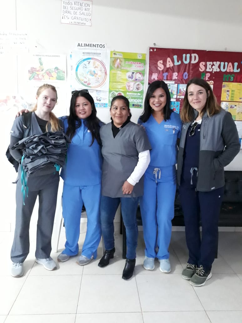 Licencia Consuelo (center), The Chief of THe Cocharcas Health Post, near Huancayo Peru, looking stylish, in her new FIGS Scrubs, and getting a donation to give out to her team from the FIGS team! (Pictured R to L Jenny, Michelle ( @mmaneevese ), Consuelo, Aileen, Mary