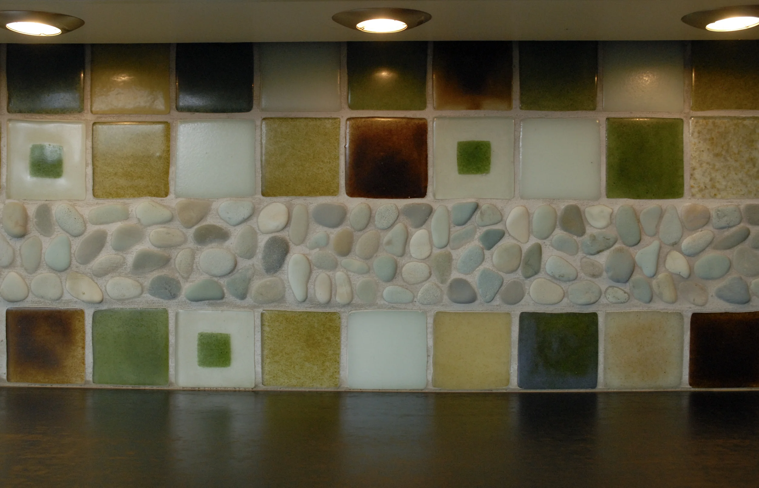 Recycled glass tile and "paperstone" countertops reflects an eco-friendly design ethic