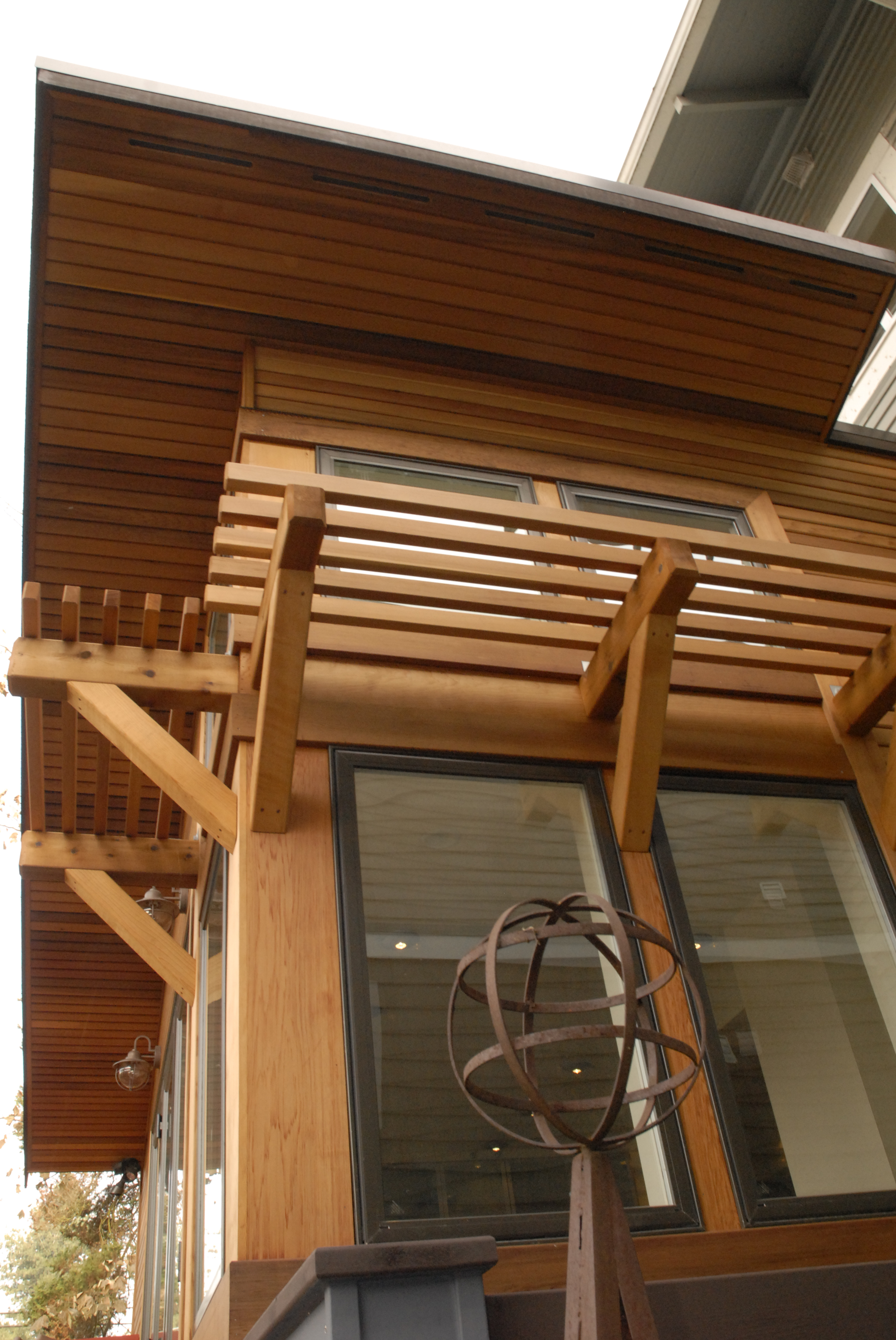 Wide overhangs with tongue and groove soffits and custom cedar awnings