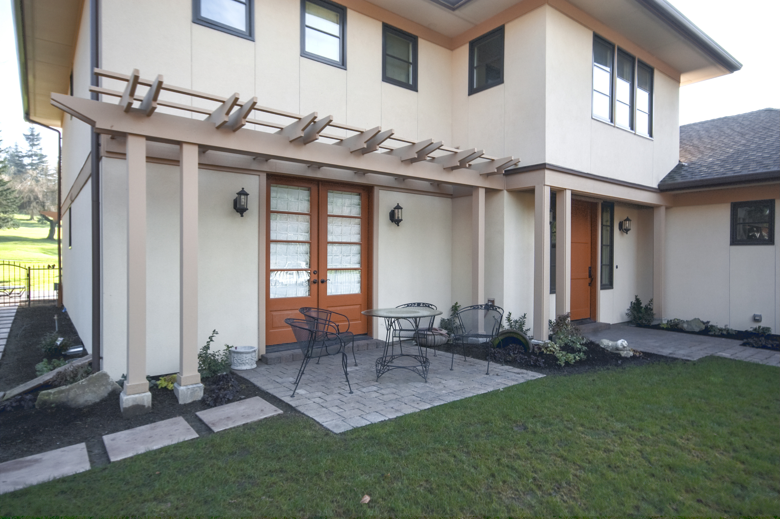 Trellis and paver patio are just a couple unique details adding appeal to the front of the home.