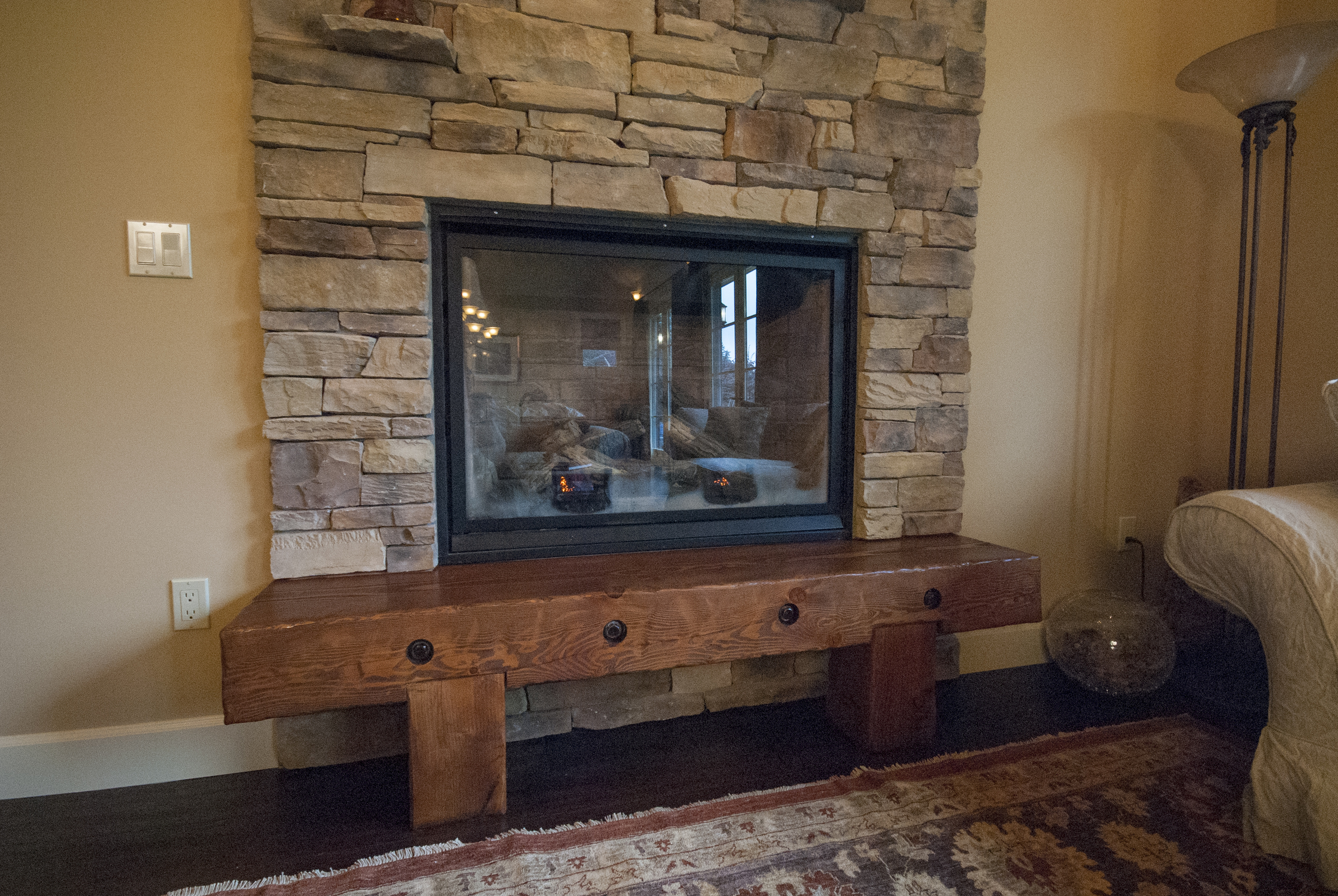 The fireplace hearth was built of recycled timber by project developer Matt Hesselgrave and is one of the clients favorite parts of the project.