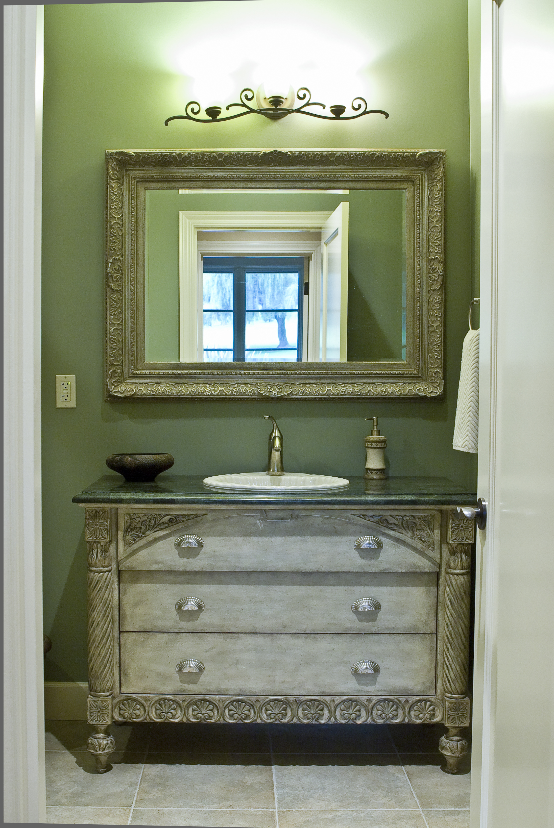 The "green bath" was our budget bath but you'd never guess it.  The sink base, an old dresser, was refinished by the client.