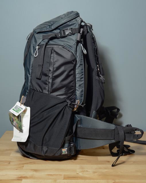 This is the side where the magic happens! At the bottom is the clip that magnetically disconnects and allows for access to the rotating camera bag. There's also a large pocket on this side which holds the included rain cover.