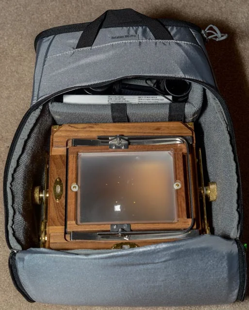 I will have to use the padded insert in the main compartment when I carry my Zone VI large format (4x5) film camera. The camera takes up the majority of the compartment, but I have space on top for a box of film, my light meter and loupe. Note: I would carry the camera body in it's protective wrap, but removed that for the sake of the photo.
