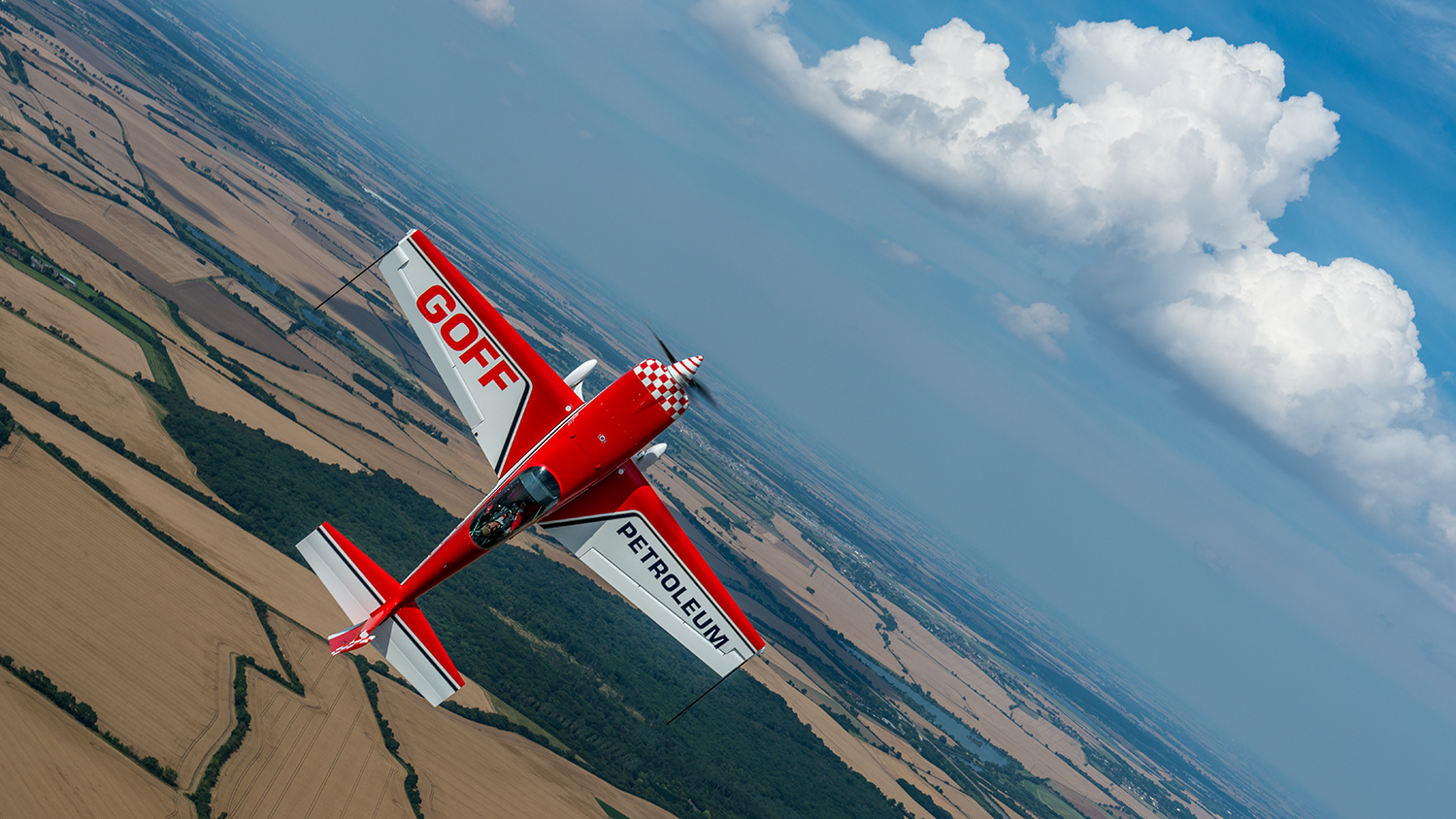 Mark maneuvering the GOFF PETROLEUM Extra towards the sky, while the fields below help remind you that we're flying in England. The photo was actually shot level, but I liked the look when I oriented it off level.