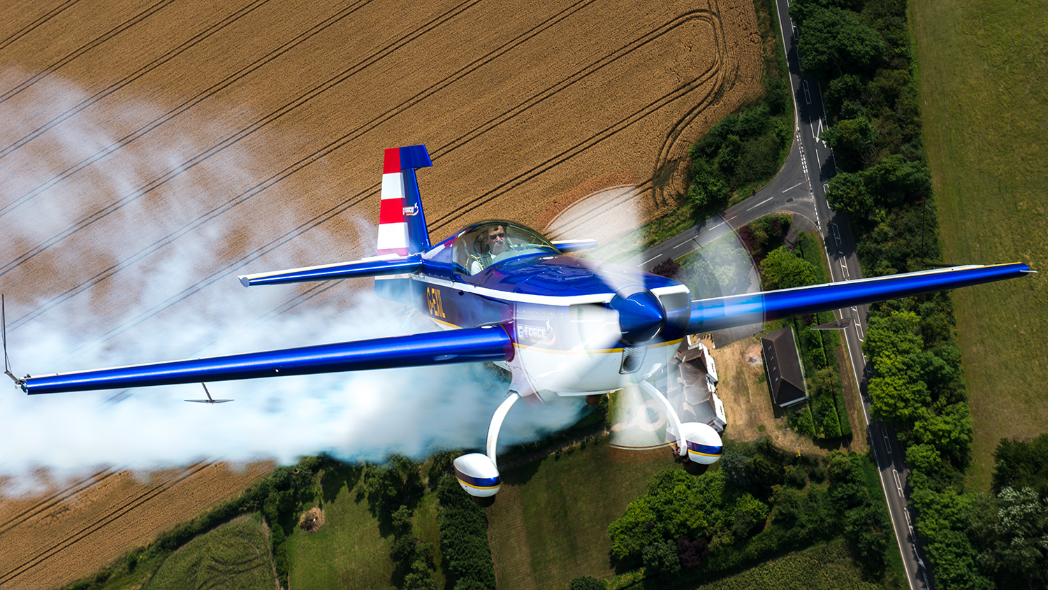 Now it's Chris' turn to show off the nose of his blue Extra as we fly over a farm house in rural England.