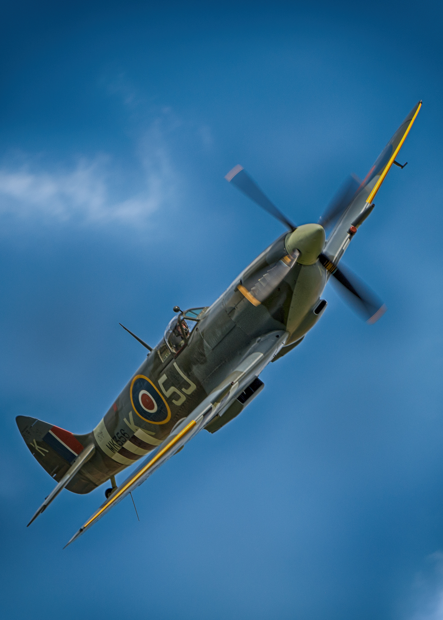 If you look closely on this Spitfire, you can see a series of white stripes on the wings and underside of this fighter - those stripes are called invasion stripes and were painted using mops and whatever white paint could be found before the Allied invasion on D-Day. These are obviously a re-paint since the real stripes were applied crudely just hours before the invasion.