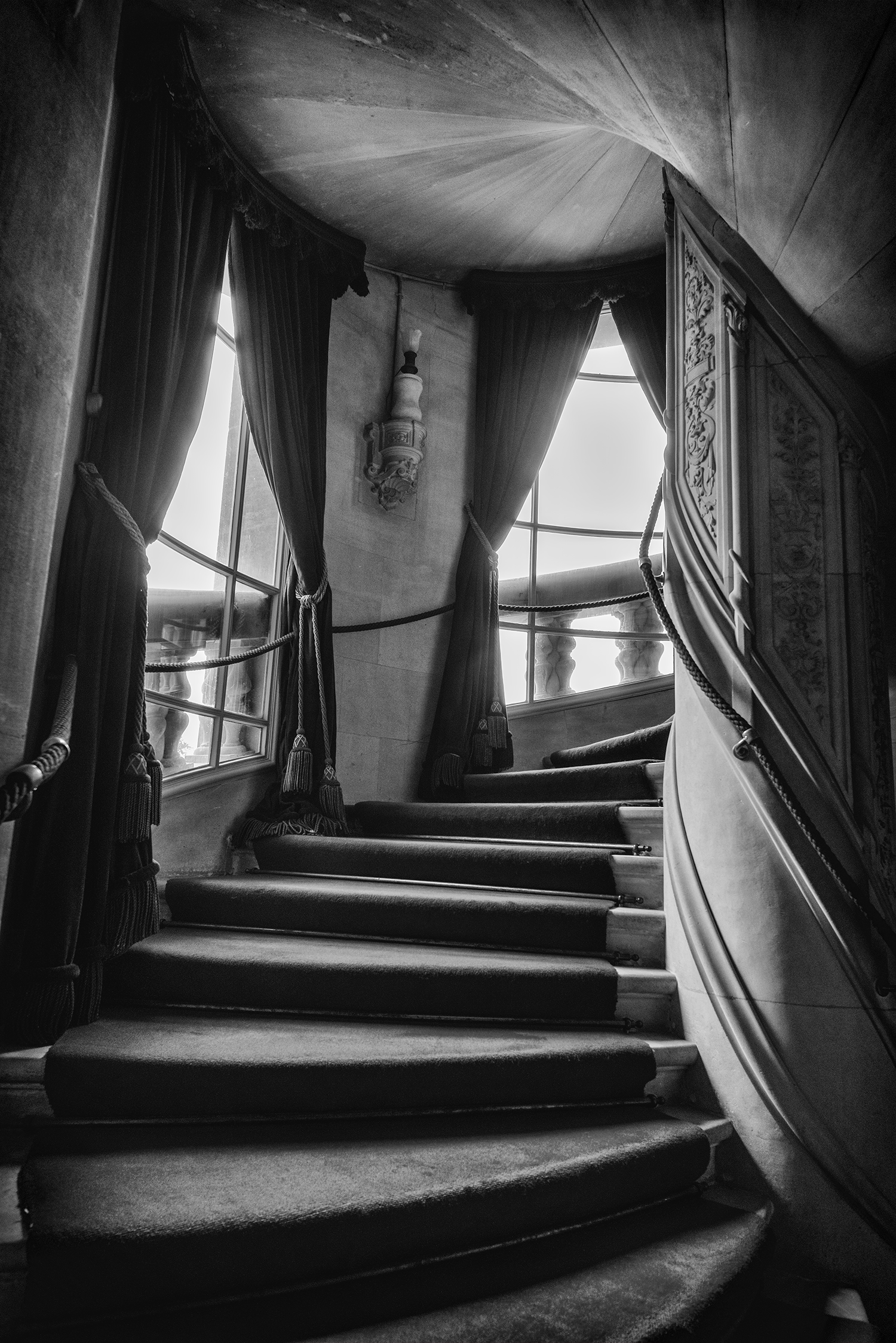 The staircase leading up to the second floor. Notice the intricate detail and carvings on the stairwell.
