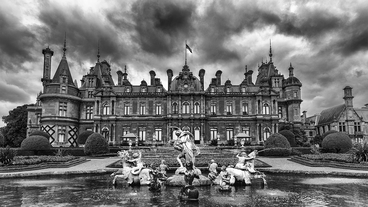 The back side of the estate manor features a large fountain and wonderful gardens
