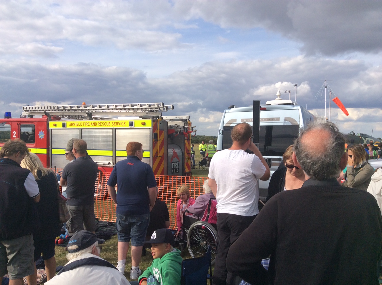 My husband, who was back in the crowd, got this distant photo of my position for context. I am in one of the neon vests between those firetrucks - it's a position that offers a great vantage point without blocking the views of the rest of the crowd.