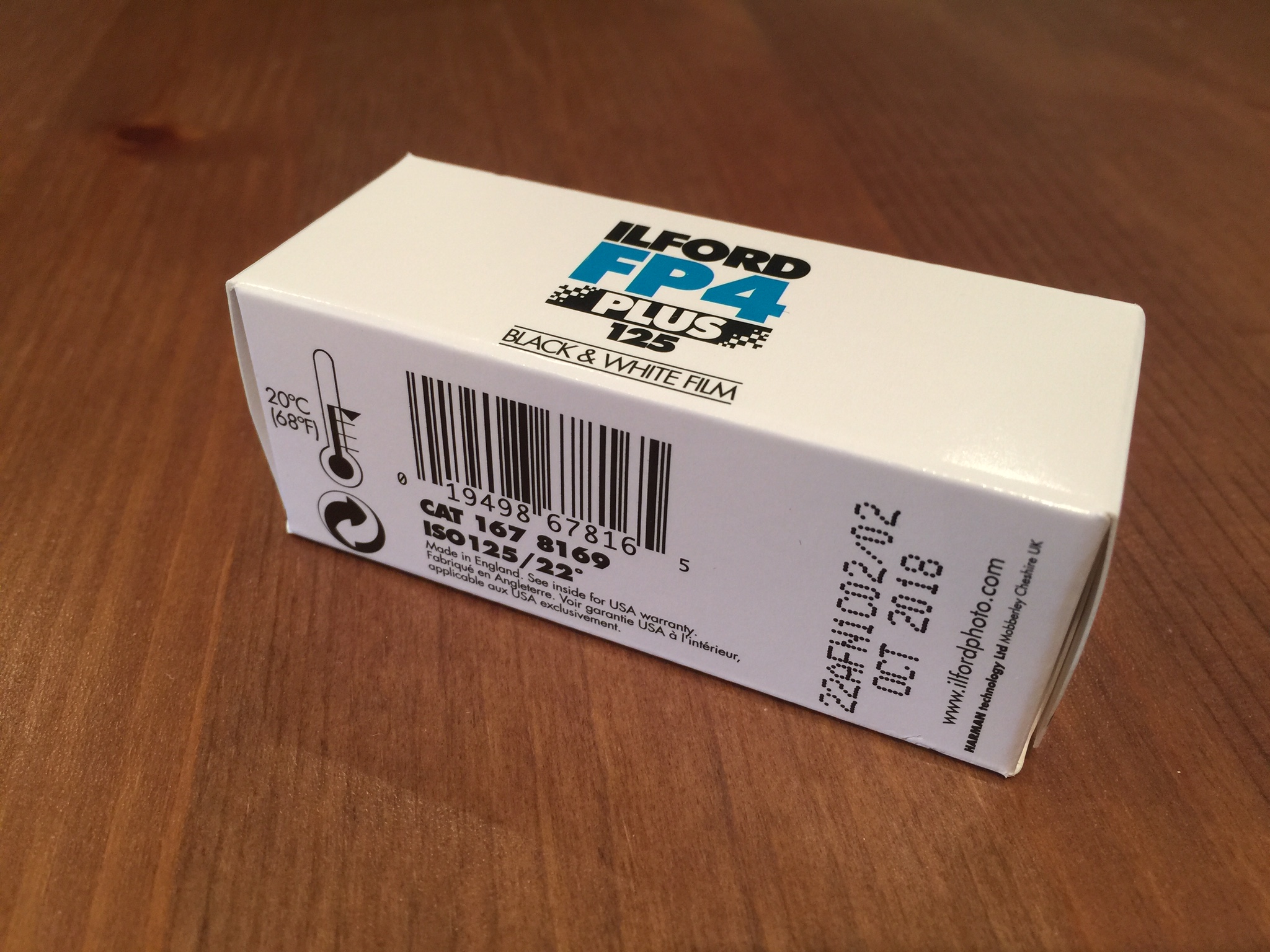 Packaging of a 120mm roll (35mm packaging is the same, just different shape). Box is white with black and blue logo lettering. Expiration date is printed on the bottom corner, along with a suggested storage temperature of less than 20*C / 68*F.