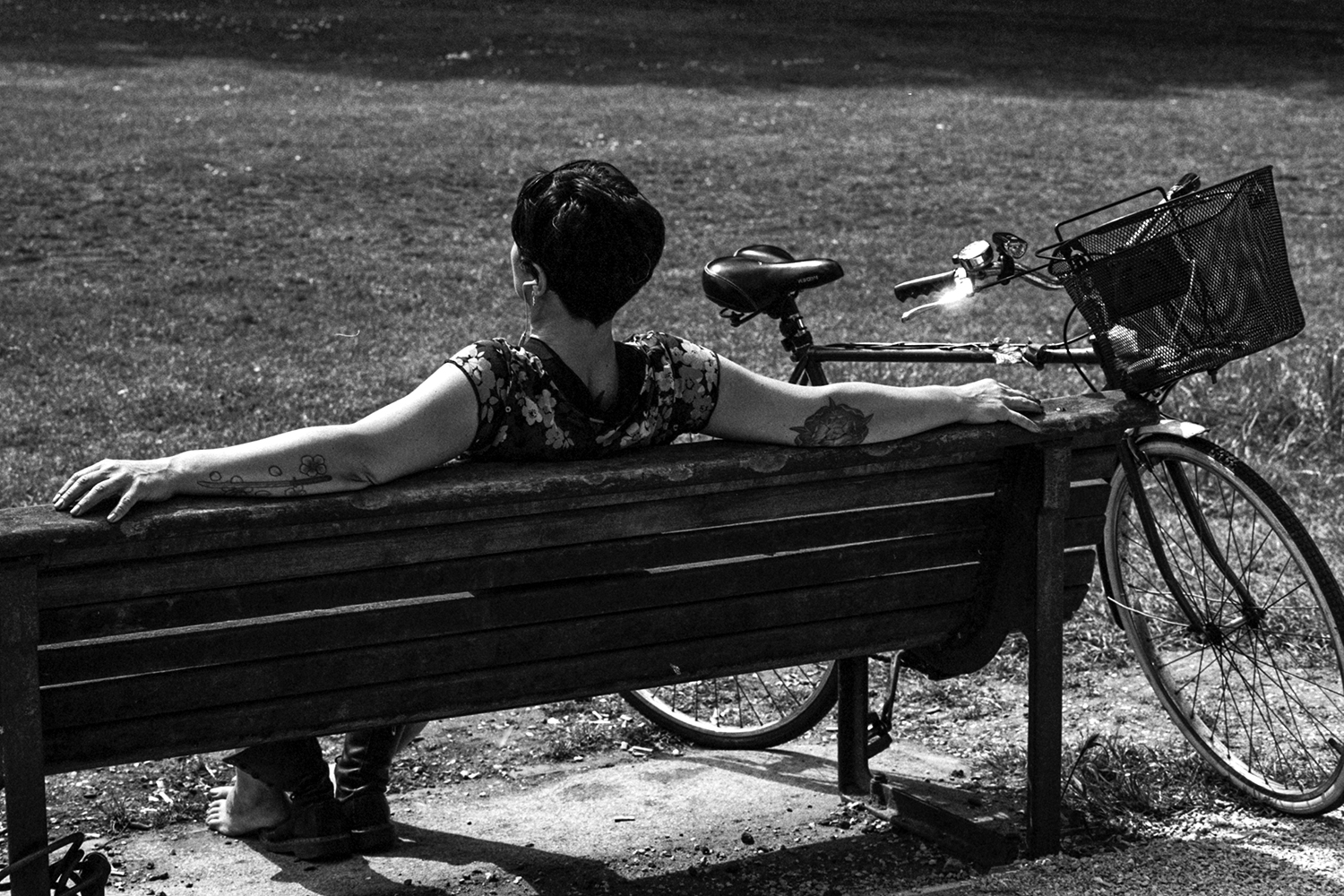 This woman was relaxing to enjoy one of the first nice days this spring. I was convinced to take the photograph because of her tattoos and seeing that she'd taken her shoes off. 