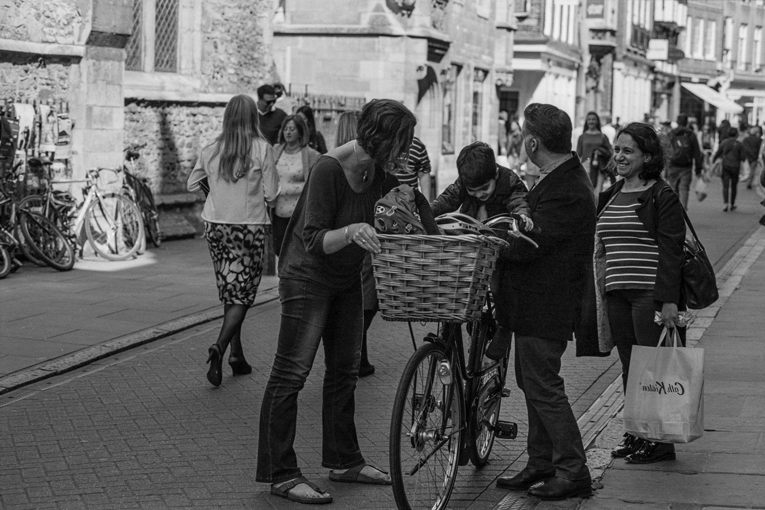 We were walking down the street and I saw the boy being hoisted onto the bike seat and knew I had to get in front of them to take a photograph. The boy was so excited to be sitting on his mom's bike!