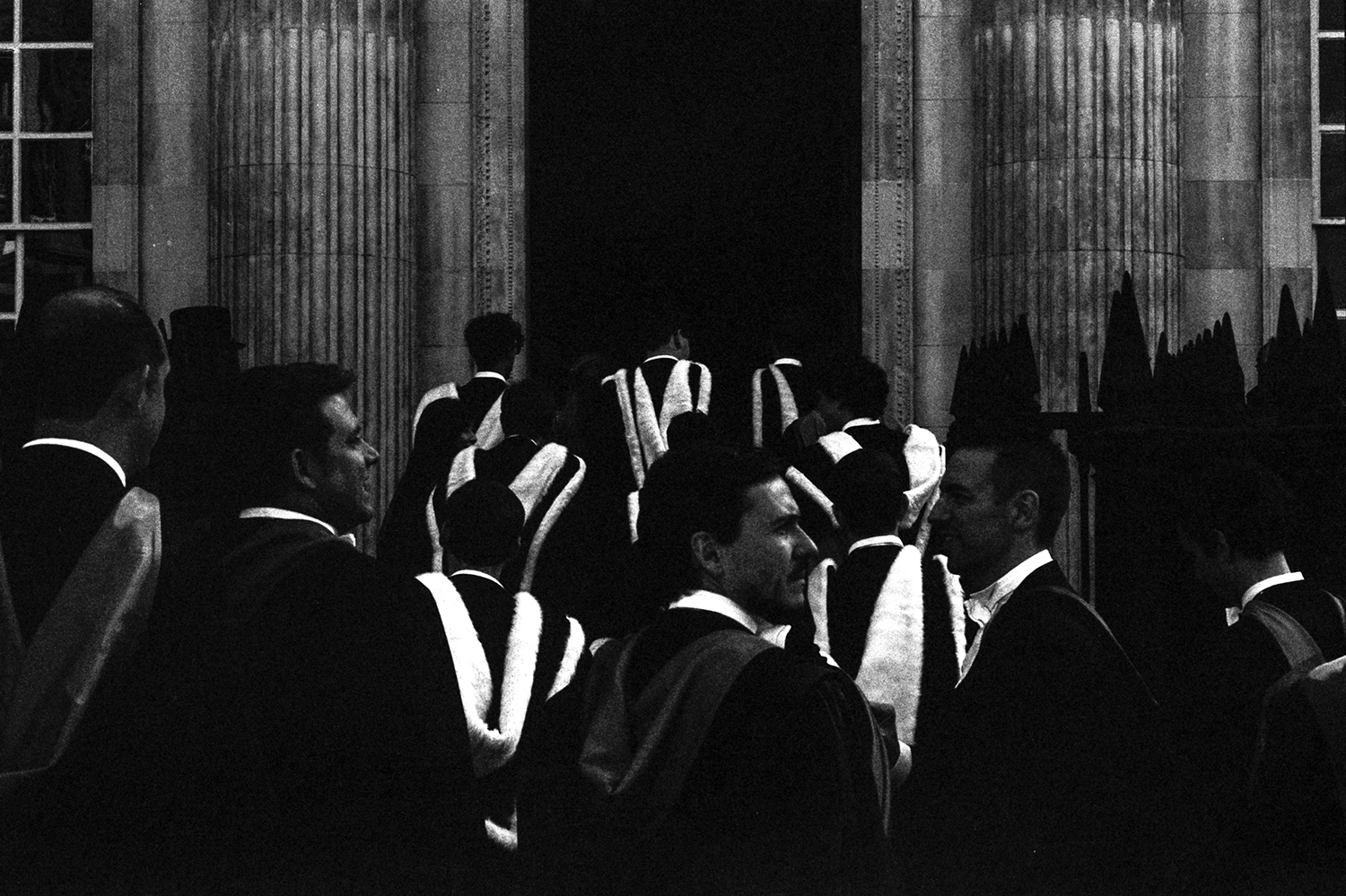 Soon-to-be graduates from one of the Cambridge University colleges line up in procession to enter their graduation ceremony. I intentionally underexposed to create a stark contrast between the black and white of their robes. 