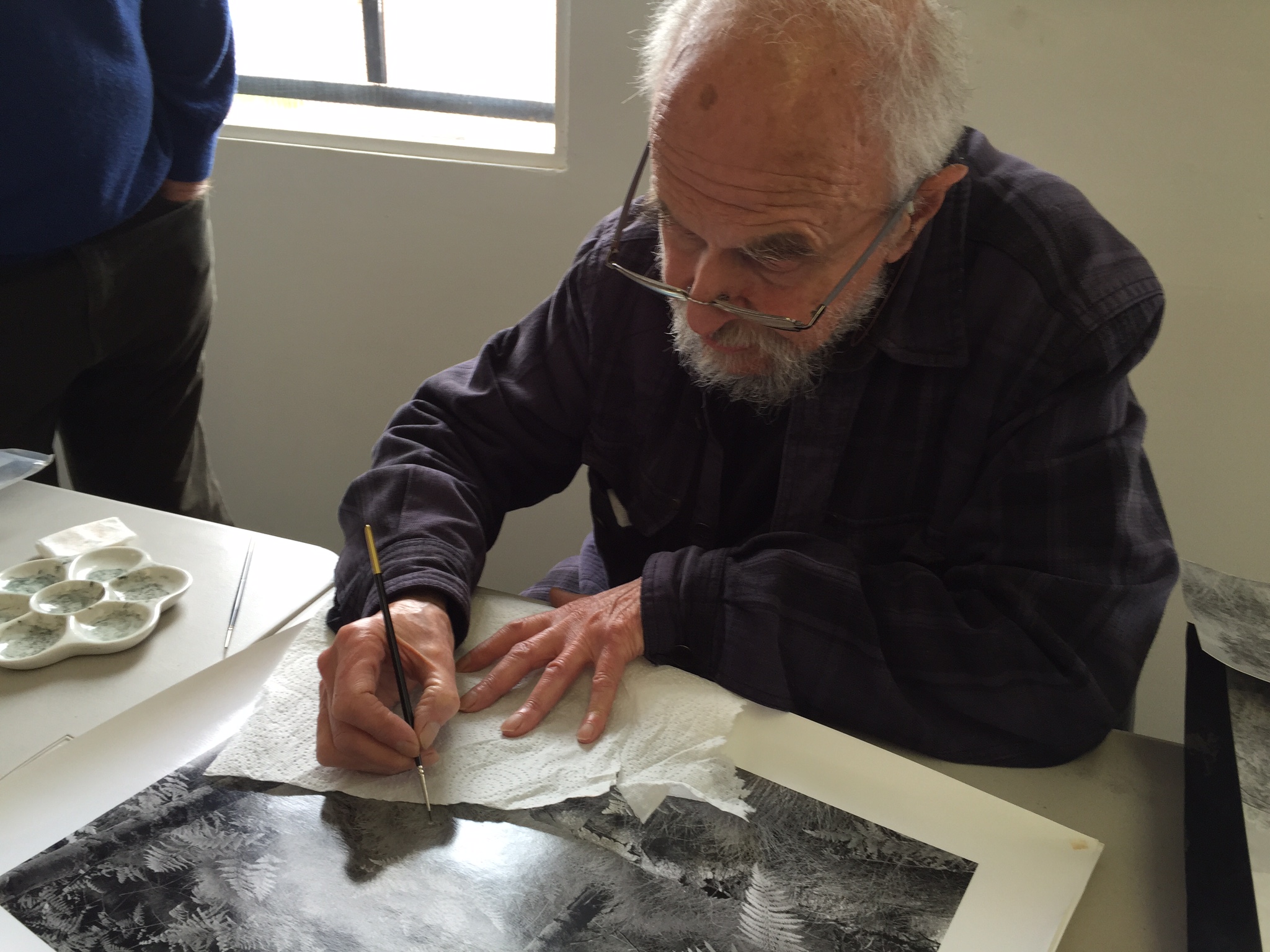 John offering a quick primer in touching up a few spots on a finished print.