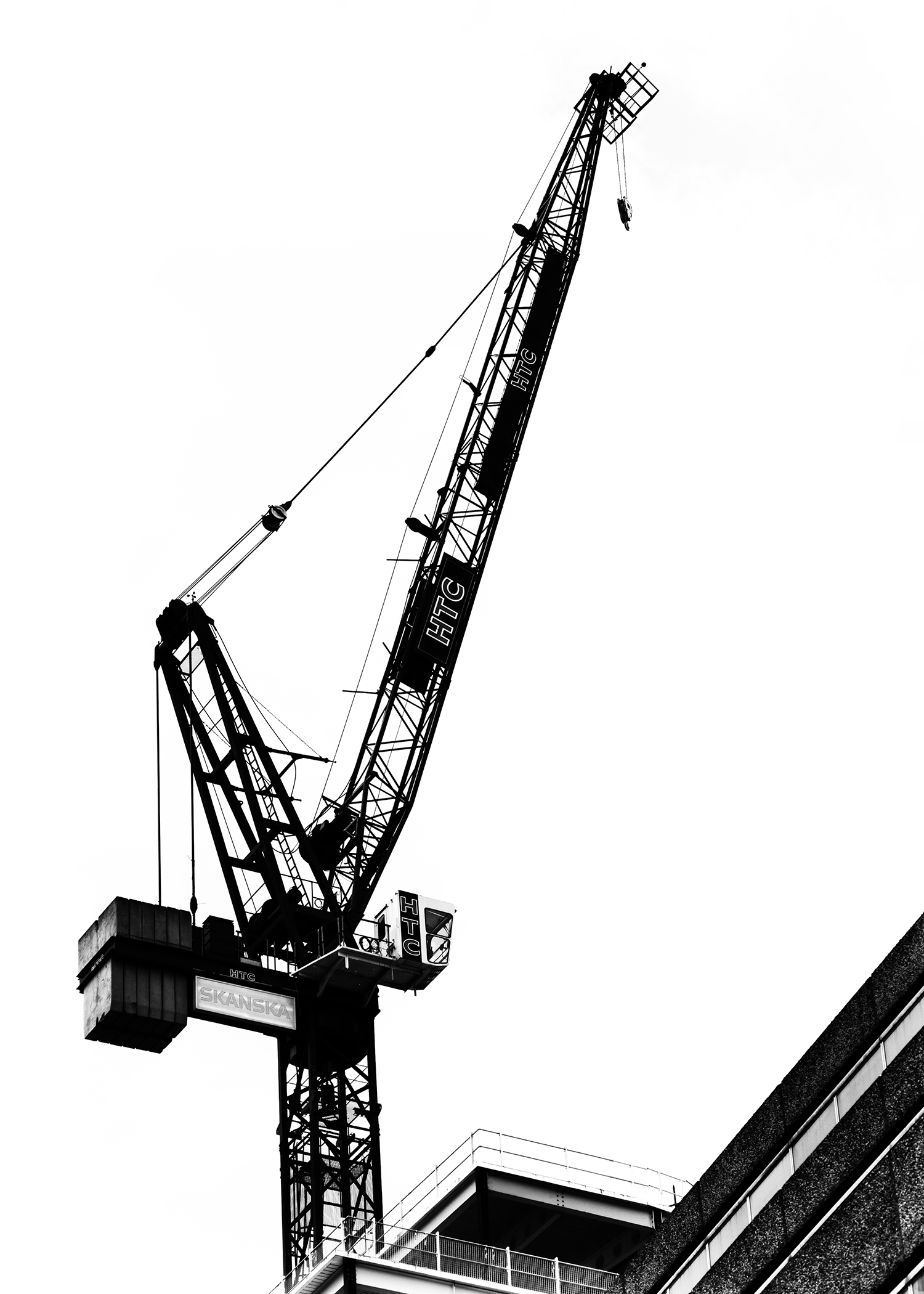 A construction project silhouette against the bright white clouds on an overcast London afternoon