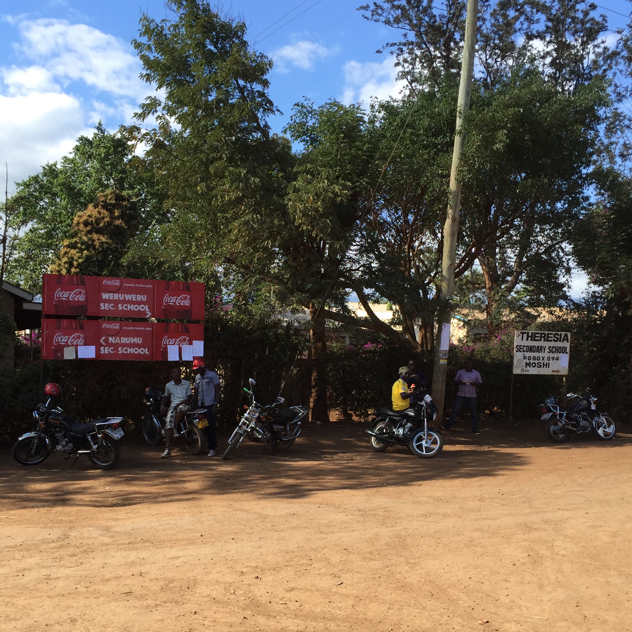 Some locals with their motorbikes gathered outside the school in Weru Weru. I guess the school serves Coke?!