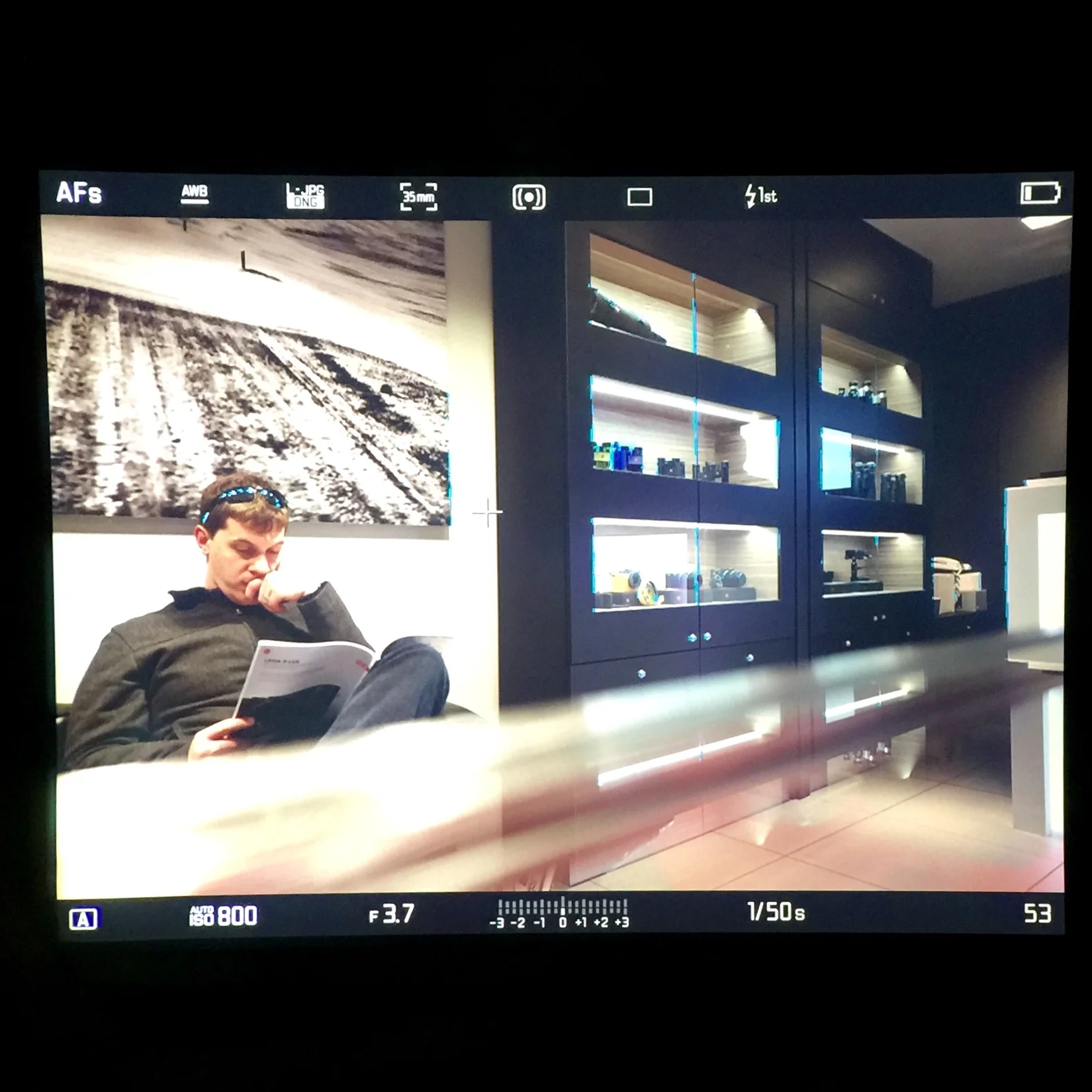 Look at that big bright viewfinder. Lot's of useful information displayed on screen. You can also see the focus peaking (the neon blue on the display cases) indicating what is in focus.