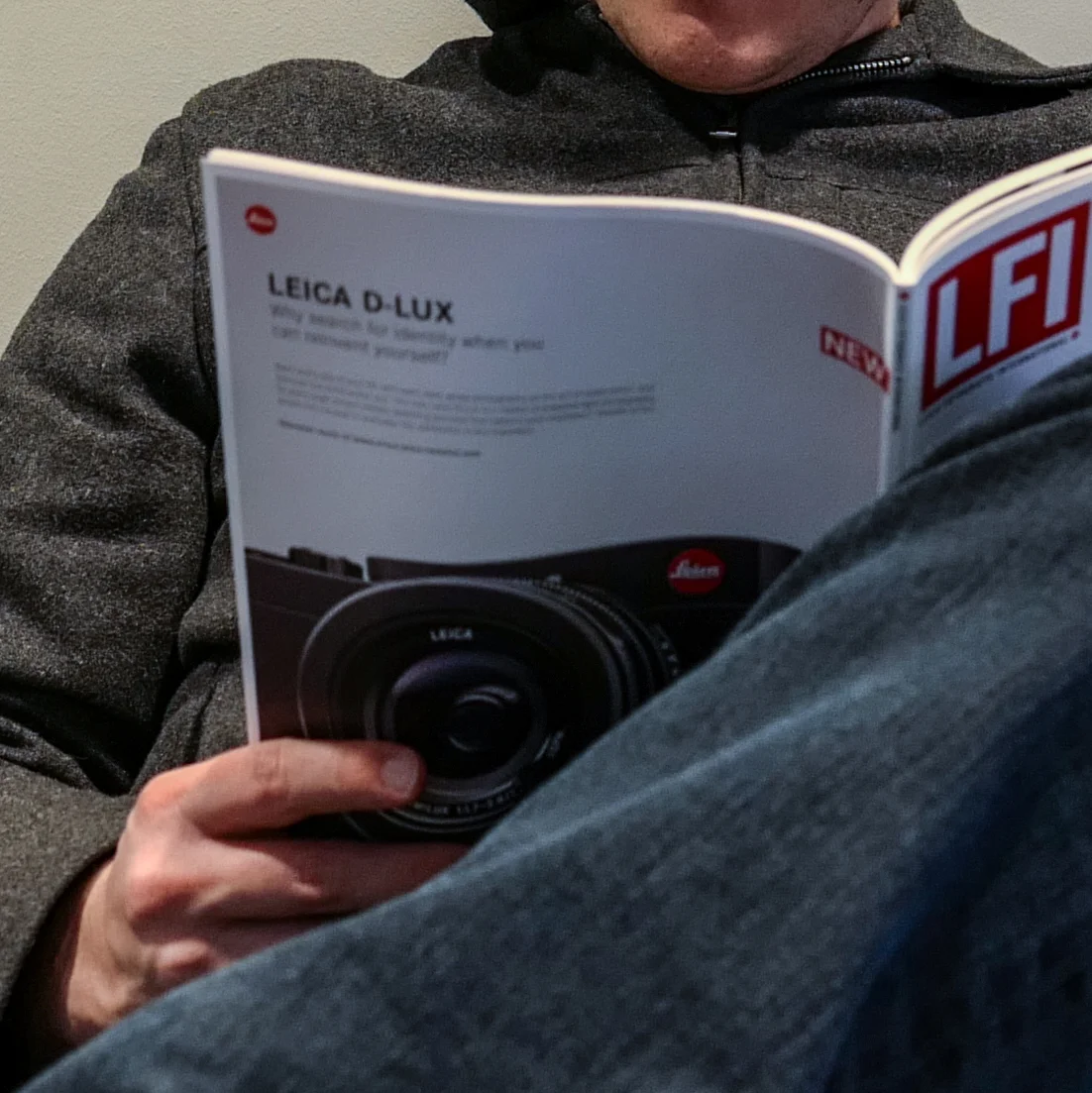 A crop from the above image. Here you can see the soft focus on the magazine and jeans, but sharp focus on the jacket and chin.