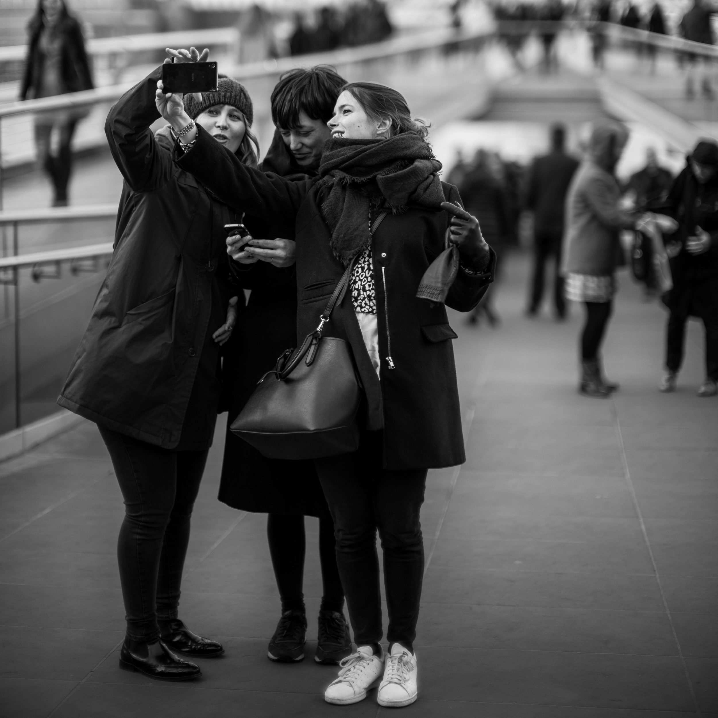 Some tourists pose for a group selfie along the London waterfront