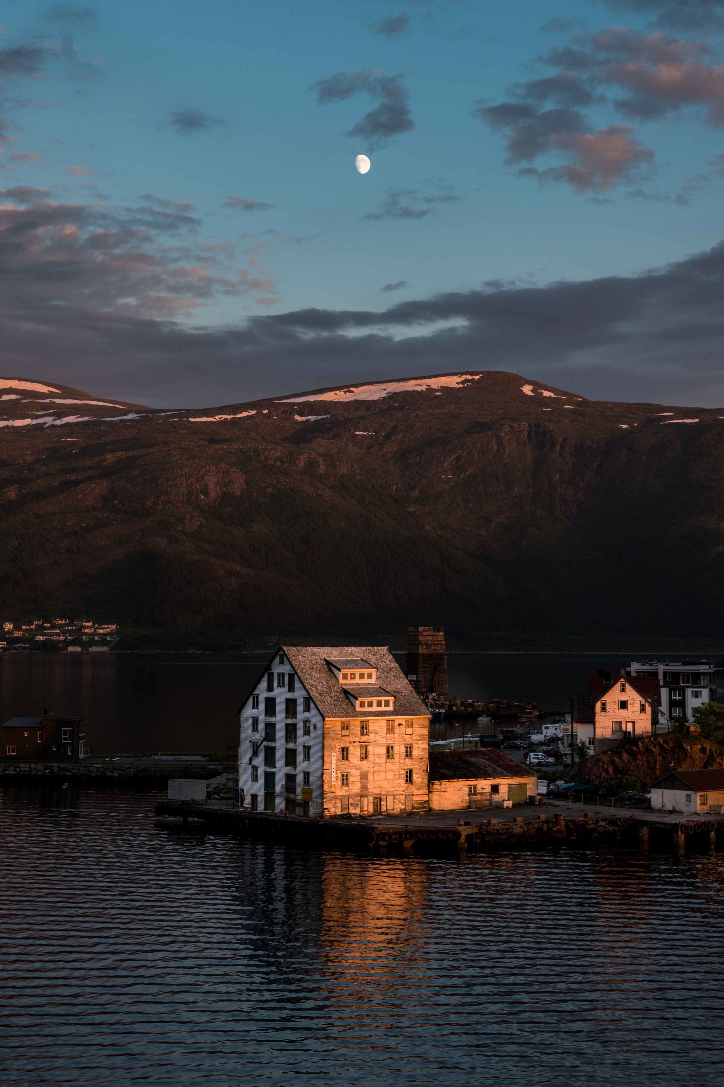 Midnight sun over a fishing warehouse in Alesund, Norway