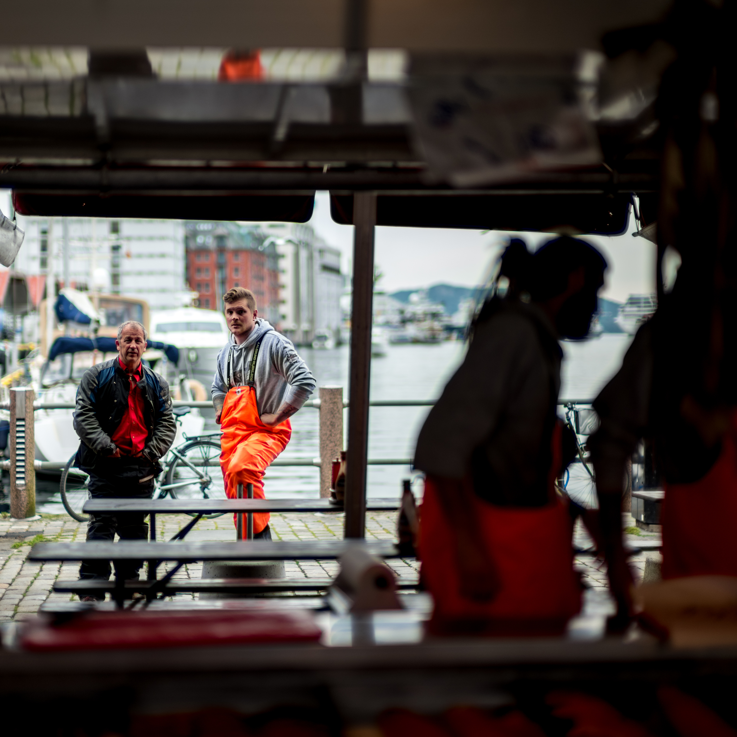 Some fishermen stop for a break in the markets of Bergen, Norway.