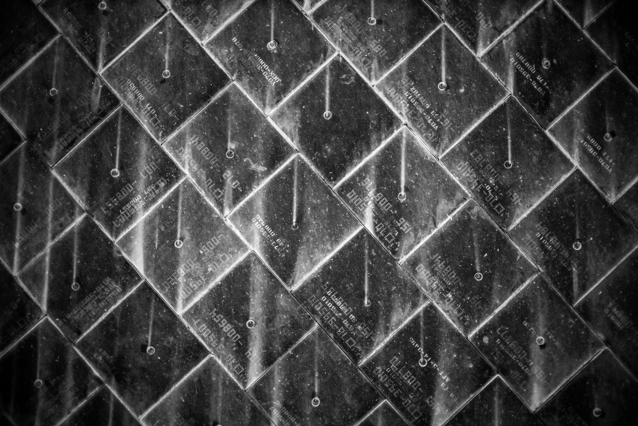 Some of the tiles on the bottom of the shuttle, designed to protect the bottom from the extreme heat caused during re-entry of the atmosphere. Space Shuttle Columbia and all of her crew were lost in 2003 when damaged tiles caused the shuttle to burn up on re-entry. Each tile has a unique serial number and placement