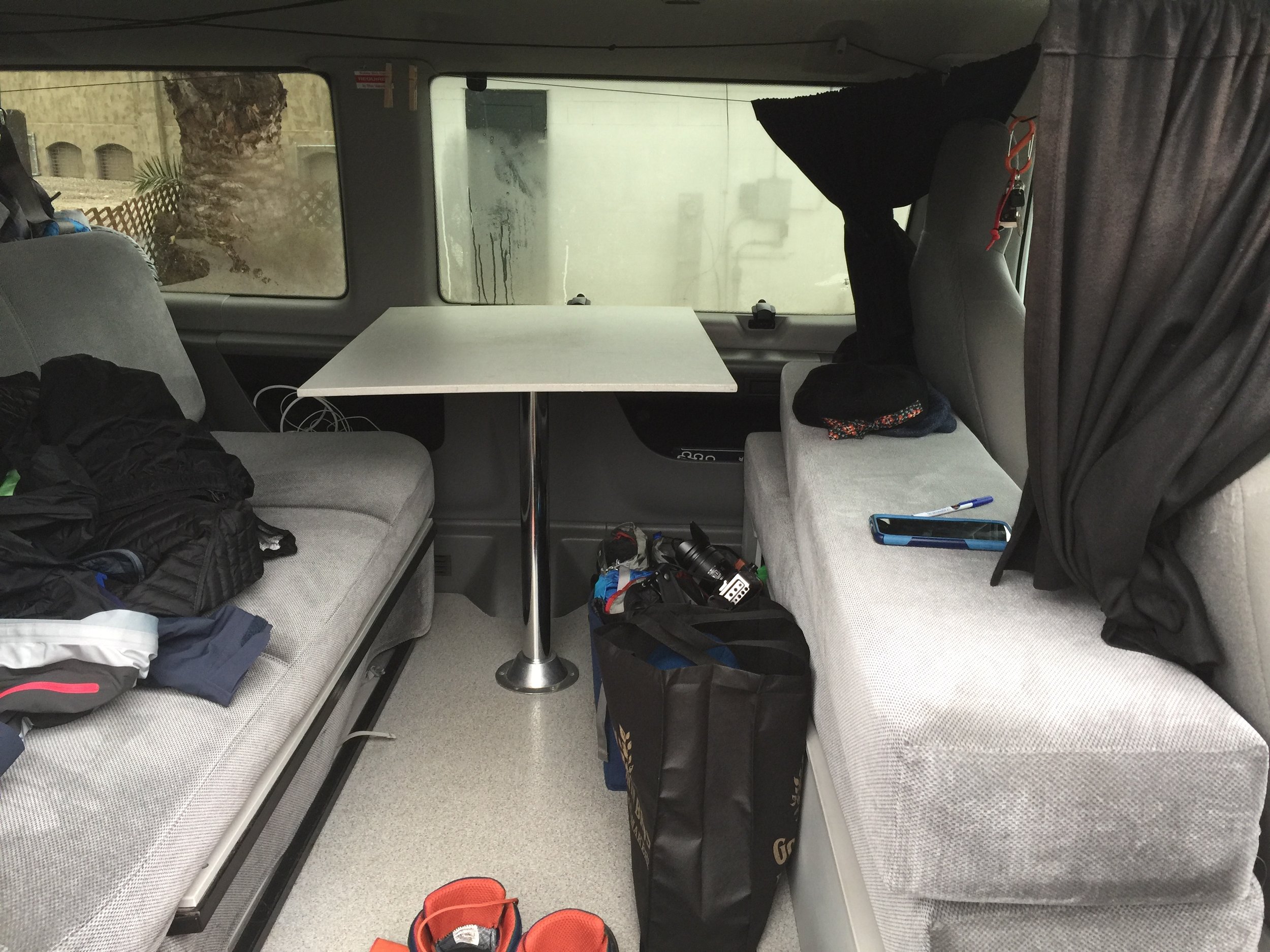 It may not look very organized, but the buckets on the ground under the table helped hold all our cameras and electronics. There are similar bins behind the couch holding our clothes.