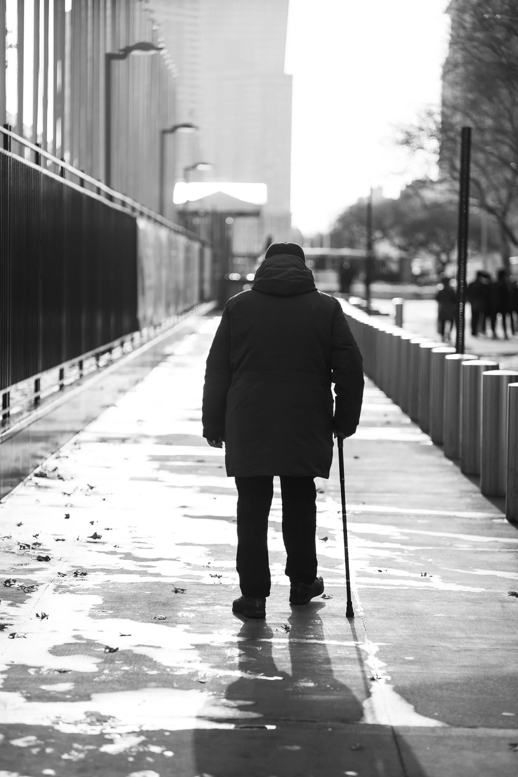 Stroll. A man walks in front of the United Nations building. The harsh light and strong shadow became the sparkle that drew me to make this image. Leica M10 with 35mm Summicron f/2.