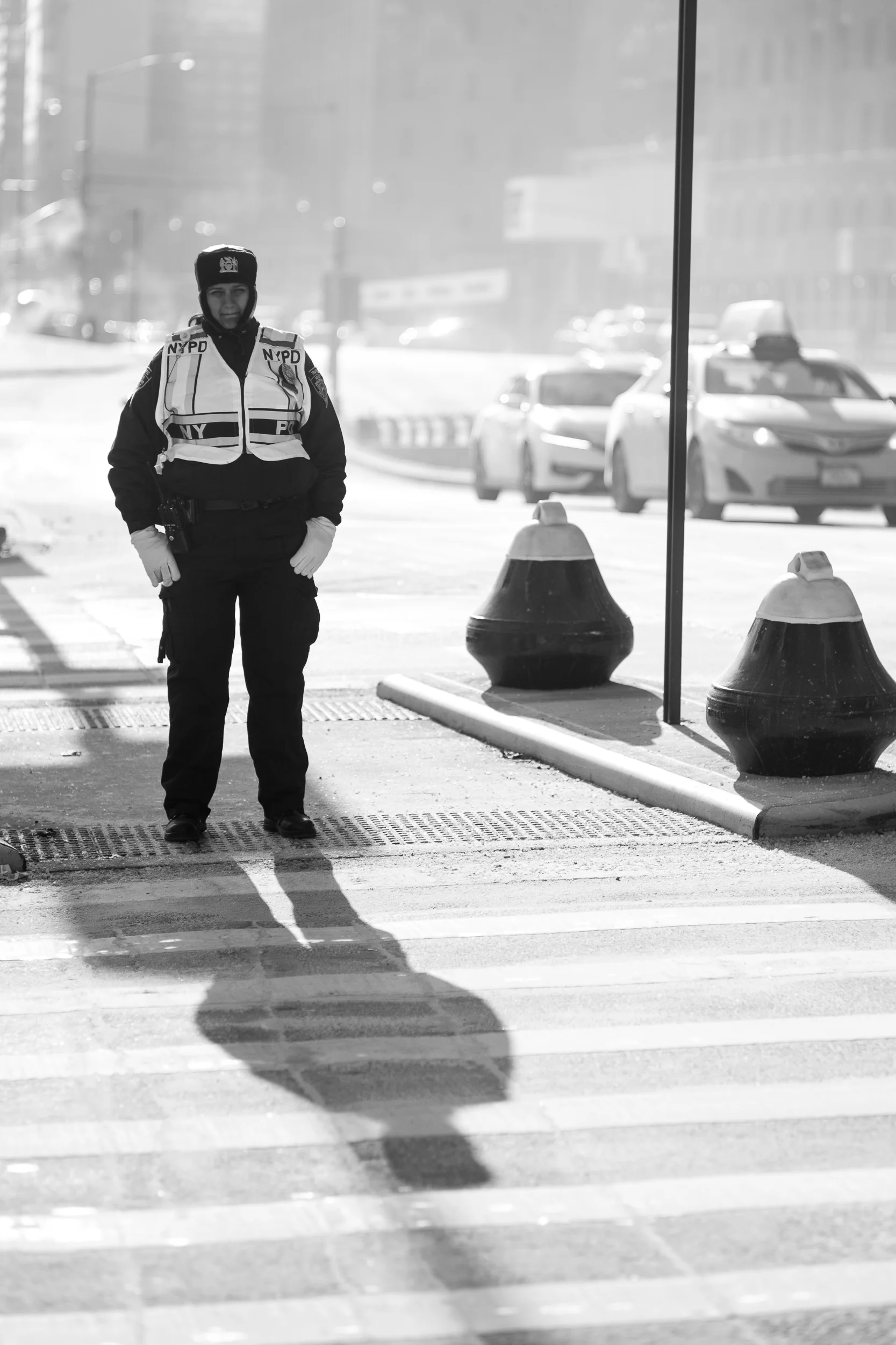 Patience. A police officer waits patiently for the light to chance before she begins directing more traffic over the intersection. The harsh light and strong shadows gave this scene the sparkle I was looking for. Leica M10 with 90mm Summicron f/2.