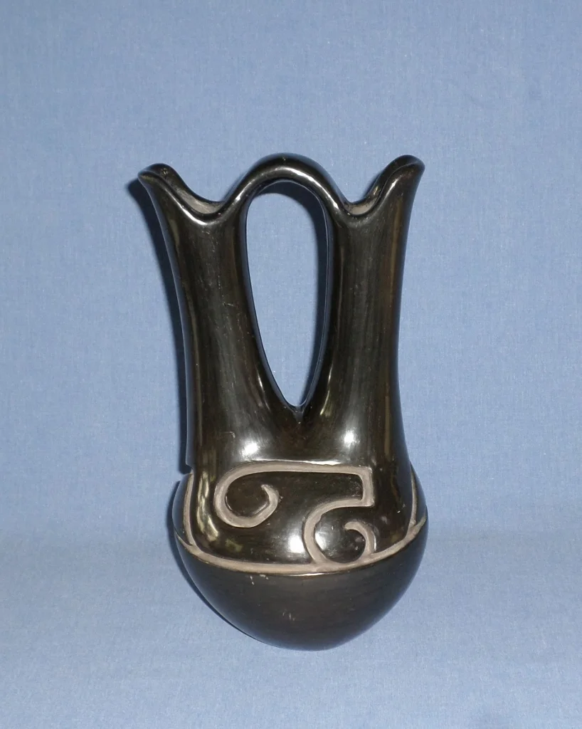 Black Wedding vase with deep carved Nature Designs c.1940 6-1/2" W (across spouts) X 12-1/4" H Price $18,000.
