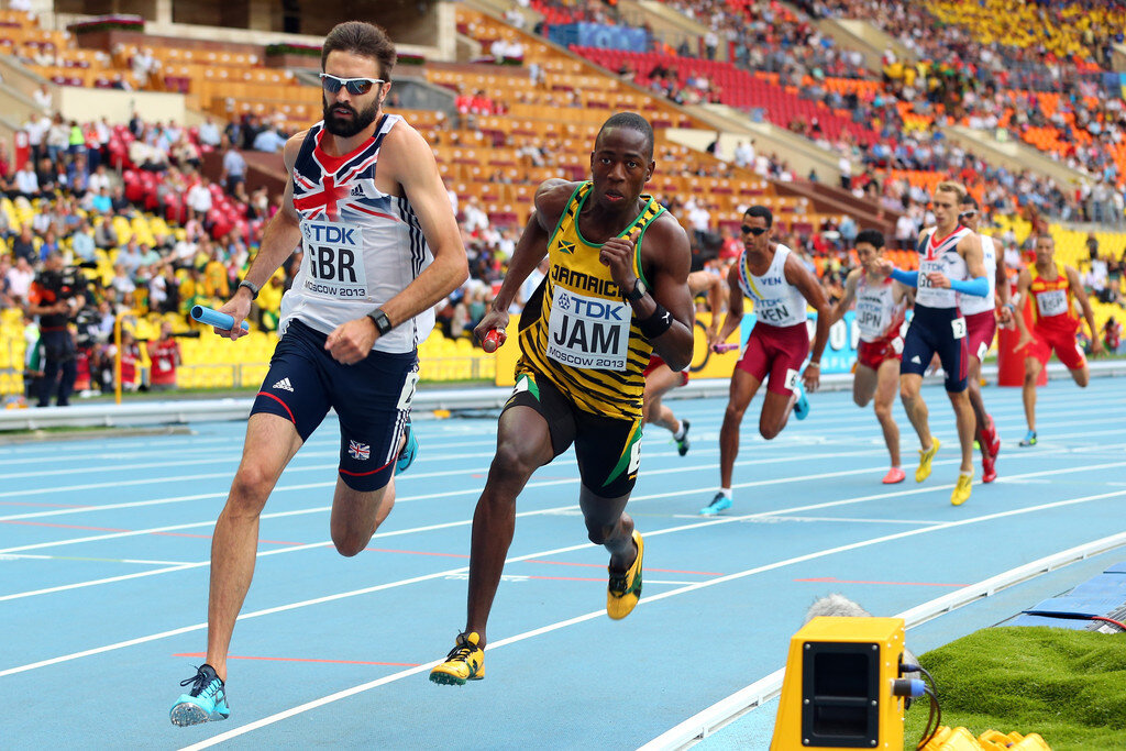 Javon Francis of Jamaica and Martyn Rooney of Great Britain compete in the Men's 4x400 metres relay heats during the 14th IAAF World Athletics Championships Moscow 2013 at Luzhniki Stadium on August 15, 2013, in Moscow, Russia. Source: Mark Kolbe/Getty Images.