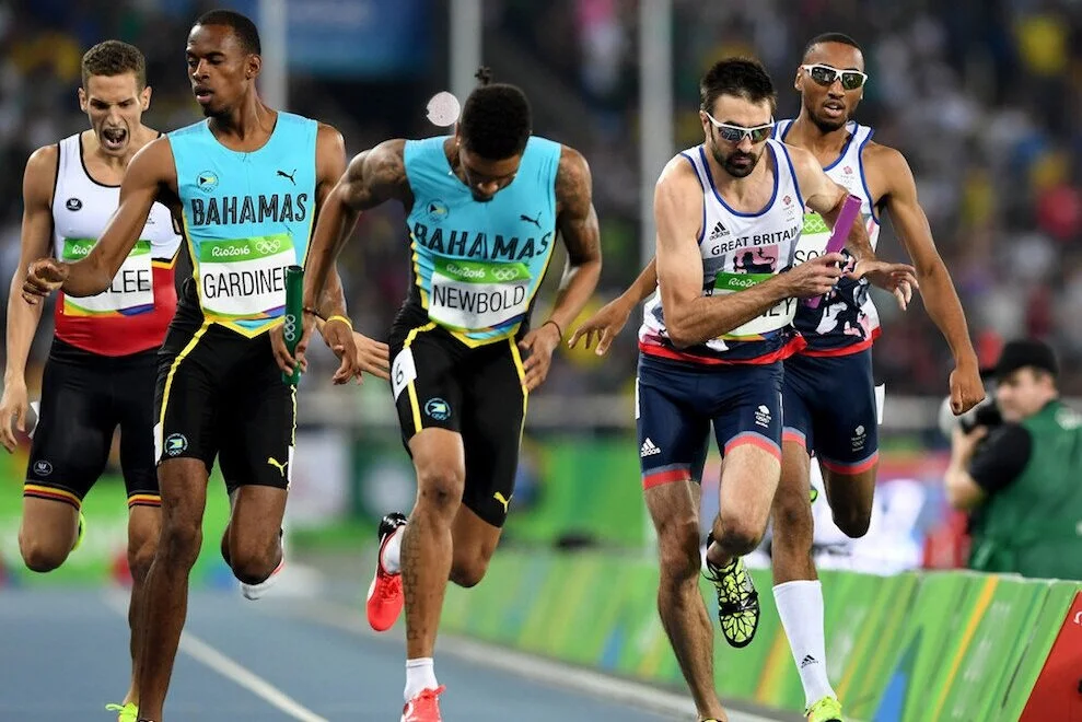 Matthew Hudson-Smith passes the baton to Martyn Rooney in Round One of the Men's 4 x 400m Relay at the Rio 2016 Olympic Games, August 19, 2016, in Rio de Janeiro, Brazil. Source: Quinn Rooney/Getty Images South America.