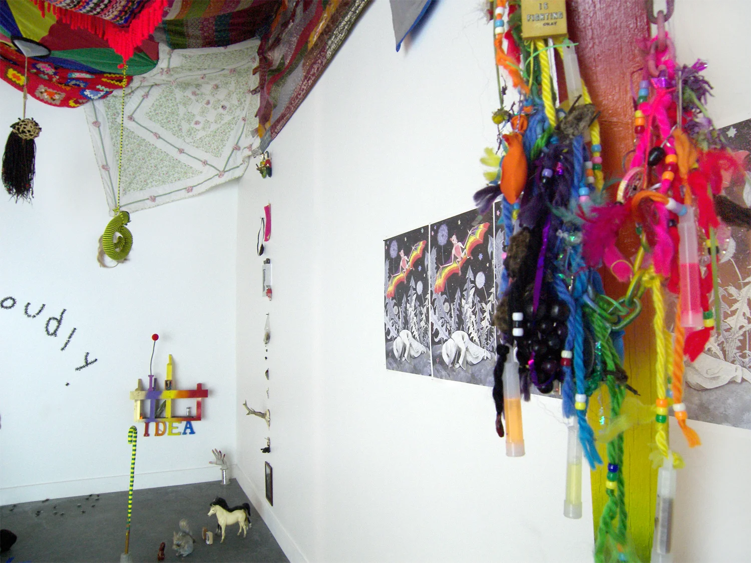 Say Nothing Real Loudly Installation with performance 2009 Installation consists of various kinds of sculpture, video projection, audio loop (“That’s What You Get For Loving Me”by Peter, Paul and Mary), found tchotchkes, stolen tchotchkes, painted wood, plastic flies, mirrors, stickers, afghans,posters, braids, glow sticks, yarn, desiccated bats, t-shirts and tape.