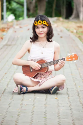 The size of a Ukulele is more proportional for the younger player.
